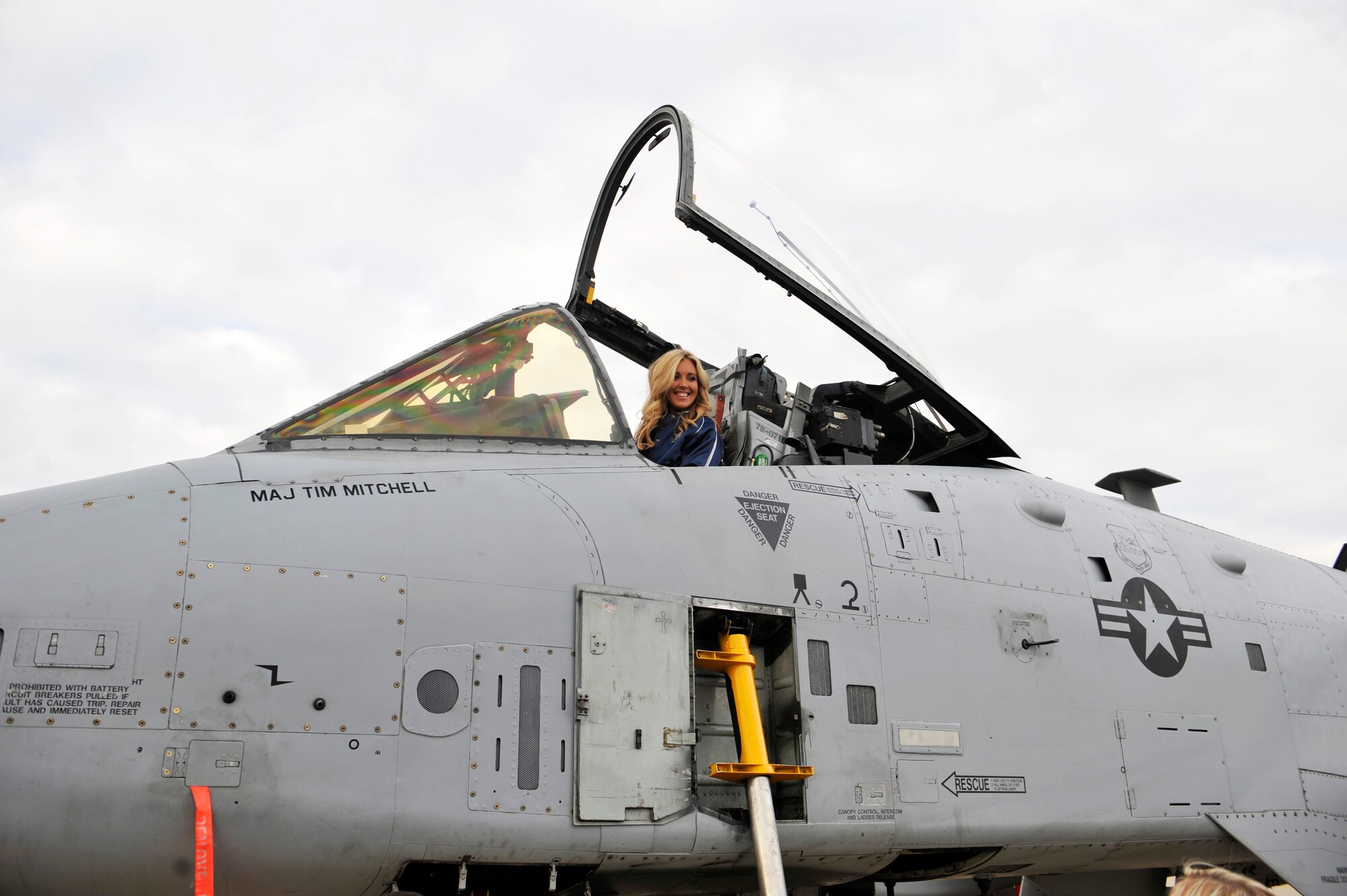 A member of the Dallas Cowboys Cheerleaders sits in an A-10 Thunderbolt II during their holiday United Services Organization tour while visiting the flight line at Osan Air Base, Republic of Korea, Dec. 18, 2013. The USO hosts tours such as these to boost service members’ morale and give them a taste of home. (U.S. Air Force photo/Staff Sgt. Emerson Nuñez)