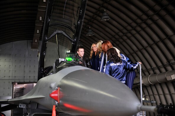 Capt. Jacob Schonig, 36th Fighter Squadron pilot, shows the Dallas Cowboys Cheerleaders the F-16 Fighting Falcon’s cockpit during their holiday United Services Organization tour at Osan Air Base, Republic of Korea, Dec. 18, 2013. This is the 36th time the Dallas Cowboy Cheerleaders have visited service members throughout the ROK. (U.S. Air Force photo/Staff Sgt. Emerson Nuñez)