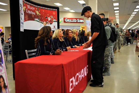Service members and dependents meet members of the Dallas Cowboys Cheerleaders during their holiday United Services Organization tour at the base Exchange food court at Osan Air Base, Republic of Korea, Dec. 18, 2013. During their visit, the cheerleaders had dinner with Airmen at the Gingko Tree dining facility, signed autographs and posed for photos with Team Osan members. (U.S. Air Force photo/Staff Sgt. Emerson Nuñez)