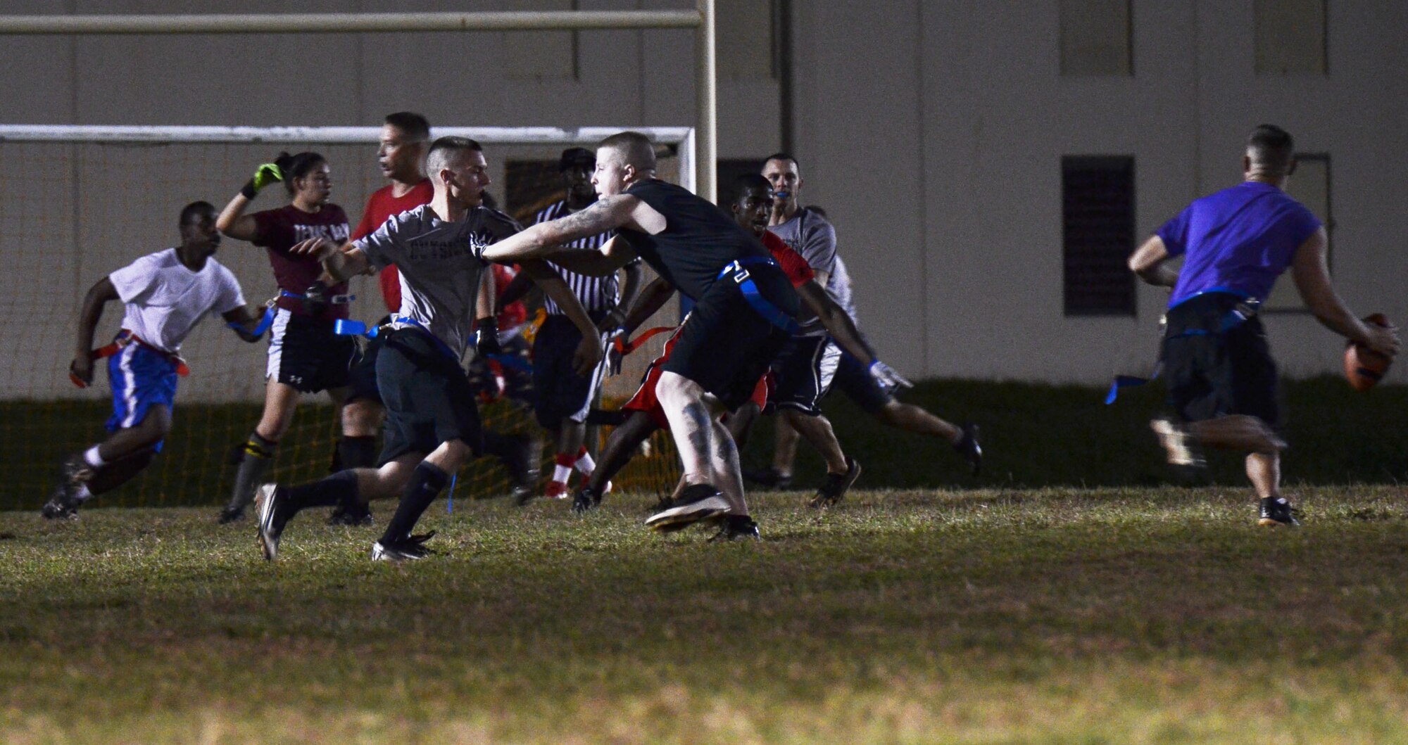 The 36th Logistics Readiness Squadron and 36th Force Support Squadron intramural football teams go head to head on Andersen Air Force Base, Guam, Dec. 19, 2013. 36th FSS was defeated by 36th LRS with a score of 21-0. (U.S. Air Force photo by Airman 1st Class Mariah Haddenham/Released)