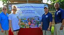 (From left to right) Col. Terry Scott, 15th Wing vice commander, Staff Sgt. Erin Frederick, 613th Air and Space Operations Center and event lead planner, Senior Master Sgt. Guadalupe Ruiz, Pacific Air Forces/A4 manager and Chief Master Sgt. Leslie Bramlett, 15th Wing command chief, pose for a group photo during the opening ceremony for the 2nd Annual Super Draft Softball Tournament in front of Joint Base Pearl Harbor-Hickam Air Force Sergeants Association donated toys, at JBPHH, Hawaii, Dec. 14, 2013.  (U.S. Air Force photo/Master Sgt. Jerome S. Tayborn)
