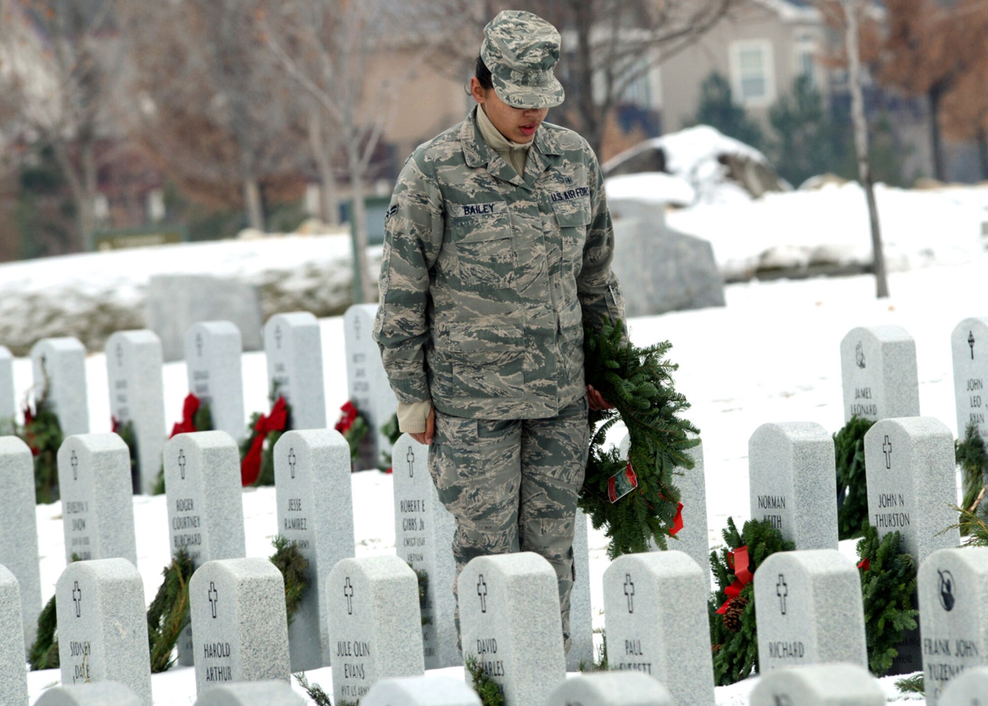 Air Force Airman 1st Class Kara Bailey, 366th Medical Operations Squadron family practice front desk technician, stands in the position of attention after saluting a fallen military member’s grave during the Wreath Across America ceremony in Boise, Idaho Dec. 13. The event was held at the Idaho State Veterans Cemetery; the event was hosted nationwide in efforts to remember and honor veterans. (U.S. Air Force photo by Tech. Sgt. JT May III/RELEASED)