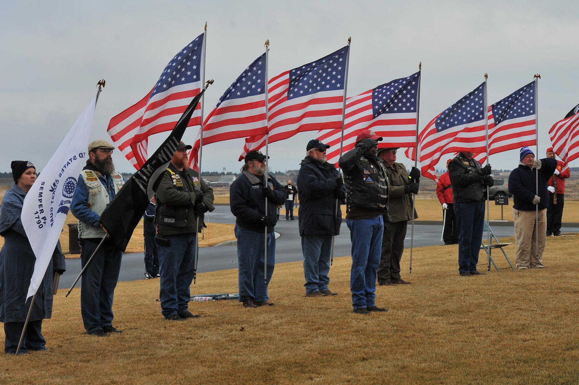 The Patriot Guard Riders hold flags in remembrance at the Fort Wright Cemetery in Spokane, Wash., Dec. 14, 2013. The event is designed to spread the message about the importance of remembering fallen heroes, honoring those who served, and teaching children about the sacrifices made by veterans and their families to preserve freedom. (U.S. Air Force photo by Staff Sgt. Veronica Montes/Released)