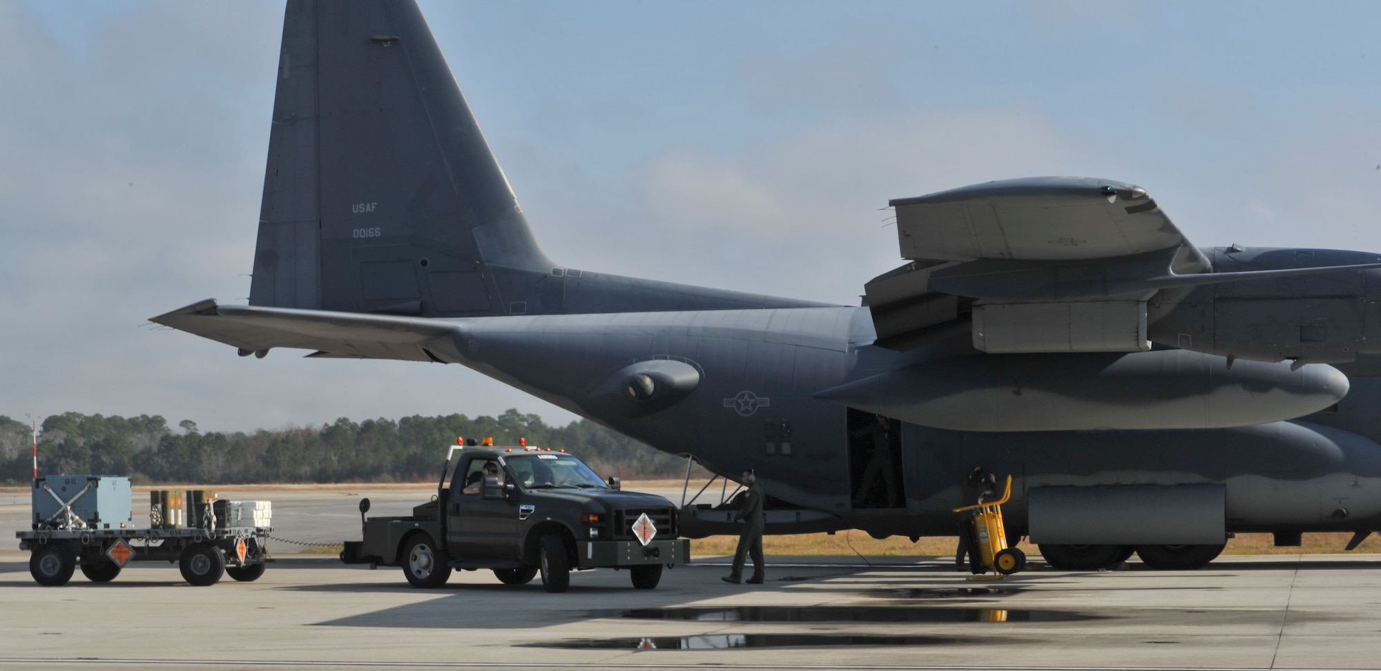 Line delivery drivers from 1st Special Operations Equipment Maintenance Squadron munitions pull up to an aircraft on Hurlburt Field, Fla., Dec. 6, 2013. Line delivery drivers loaded 105mm, 40mm ammunition, and special flares onto an AC-130U Spooky gunship. (U.S. Air Force photo/Staff Sgt. John Bainter)