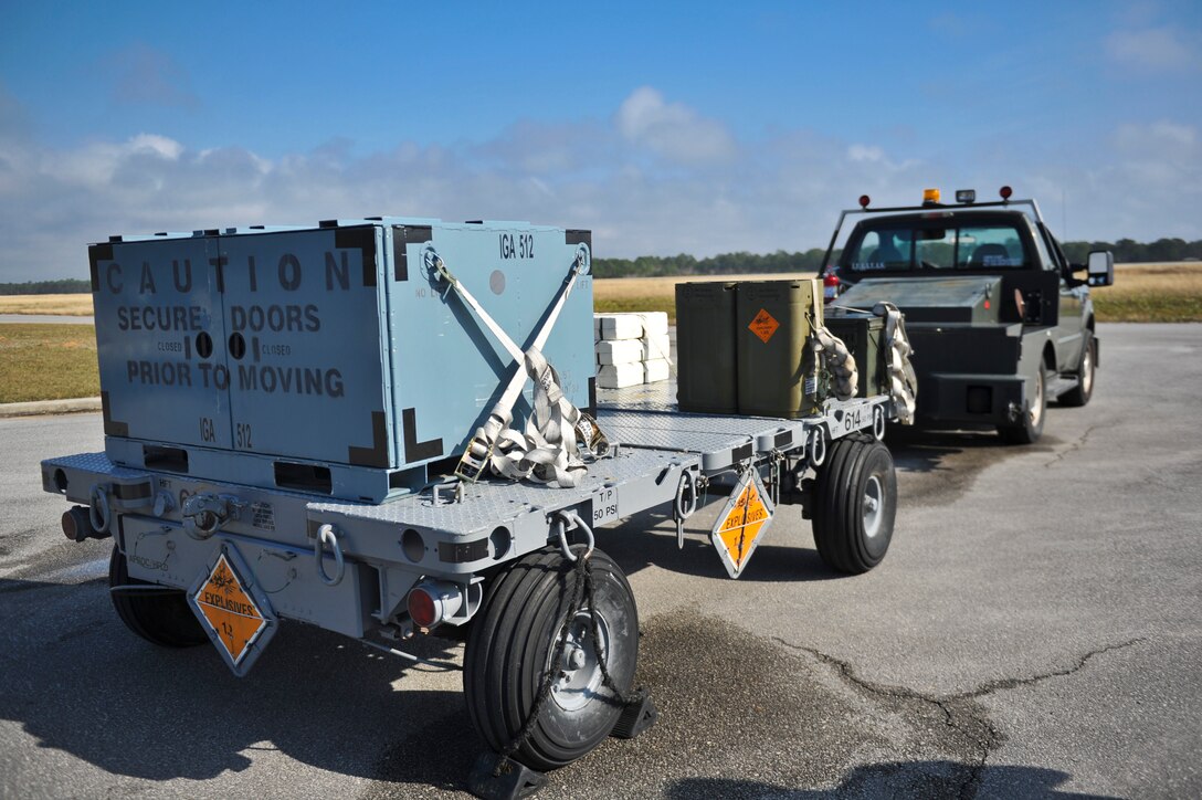 A munitions trailer sits on the flightline access road at Hurlburt Field, Fla., Dec. 6, 2013. Line delivery drivers waited for an AC-130U Spooky gunship to arrive. (U.S. Air Force photo/Staff Sgt. John Bainter)