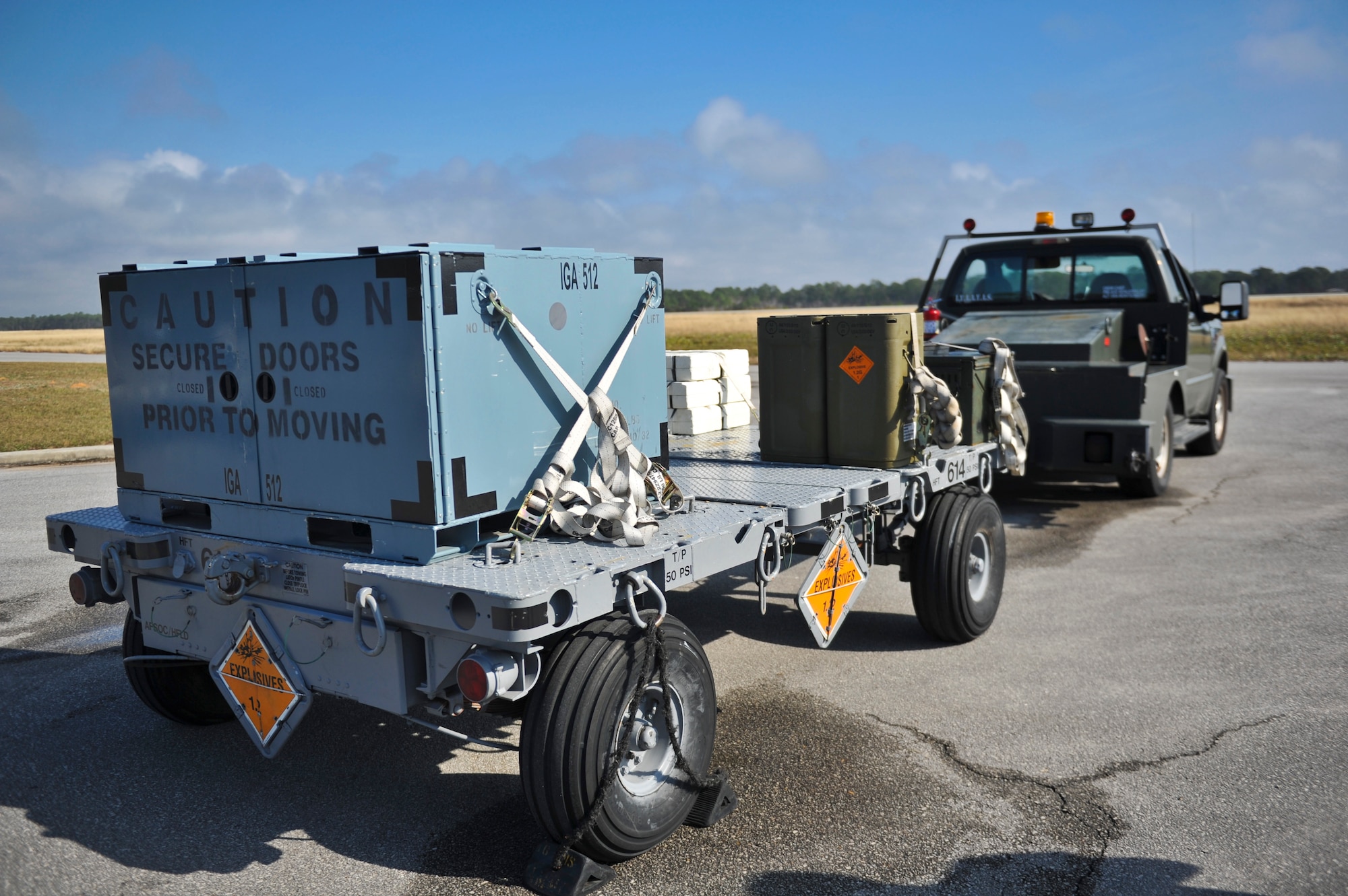 A munitions trailer sits on the flightline access road at Hurlburt Field, Fla., Dec. 6, 2013. Line delivery drivers waited for an AC-130U Spooky gunship to arrive. (U.S. Air Force photo/Staff Sgt. John Bainter)