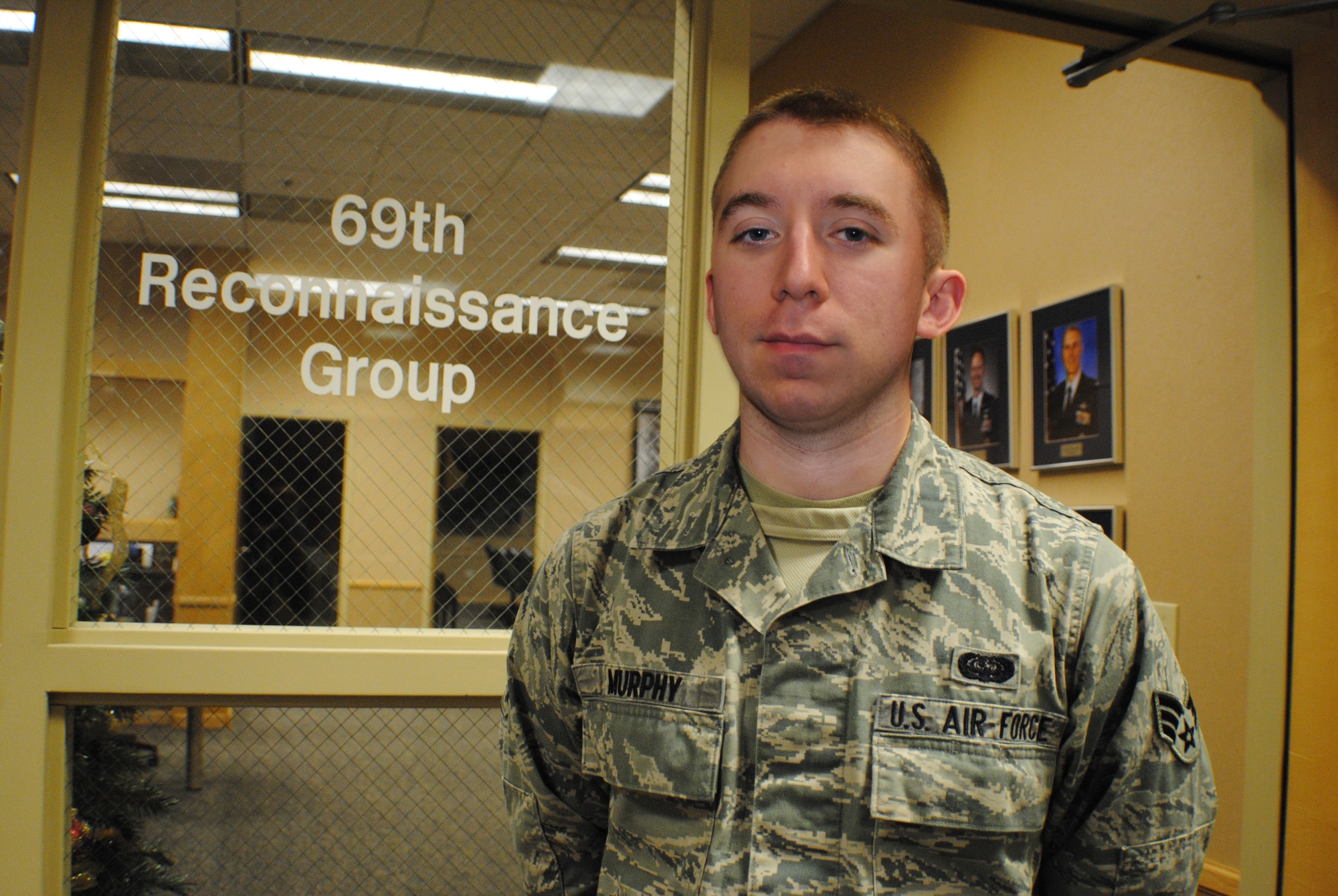 Senior Airman Michael Murphy, 69th Reconnaissance Group knowledge operations manager, stands outside the doorway to his working section Dec. 13, 2013, on Grand Forks Air Force Base, N.D. The 22-year-old from Rapid City, S.D., was named the base’s Warrior of the Week for the third week of December 2013. (U.S. Air Force photo/Staff Sgt. Luis Loza Gutierrez) 
