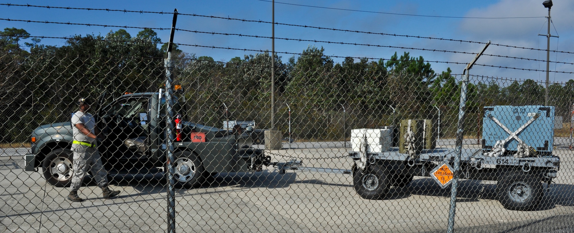 Senior Airman Marcus Montgomery, 1st Special Operations Equipment Maintenance Squadron munitions line delivery driver, does a final walk around of a munitions trailer on Hurlburt Field, Fla., Dec. 6, 2013. Line delivery drivers ensured all munitions are secured before transport. (U.S. Air Force photo/Staff Sgt. John Bainter)