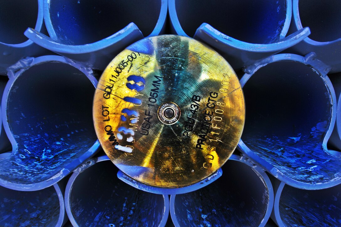 A 105mm round rests in a munitions trailer on Hurlburt Field, Fla., Dec. 6, 2013. Aircrew members rejected the round after a loose crimp was detected during the loading process. (U.S. Air Force Photo Illustration/Staff Sgt. John Bainter)