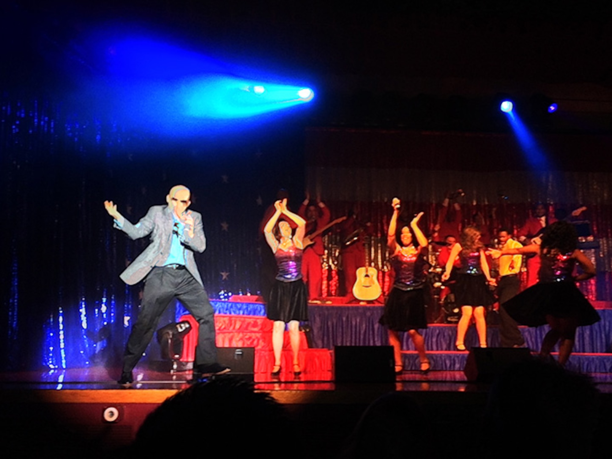 Staff Sgt. Jeffrey Collins, a reservist with the 4th Combat Camera Squadron, March Air Reserve Base, Calif., performs the role of musical sensation, Pitbull, during the kick-off show of the 2013 Tops in Blue All Star tour at Joint Base San Antonio, Dec. 7, 2013. Collins was one of several former TIB members recalled for the 60th anniversary All-Stars tour of the entertainment group, a first of its kind for TIB. They are touring overseas, performing for deployed military members and their families through December. (Courtesy photo/Jennifer Collins)