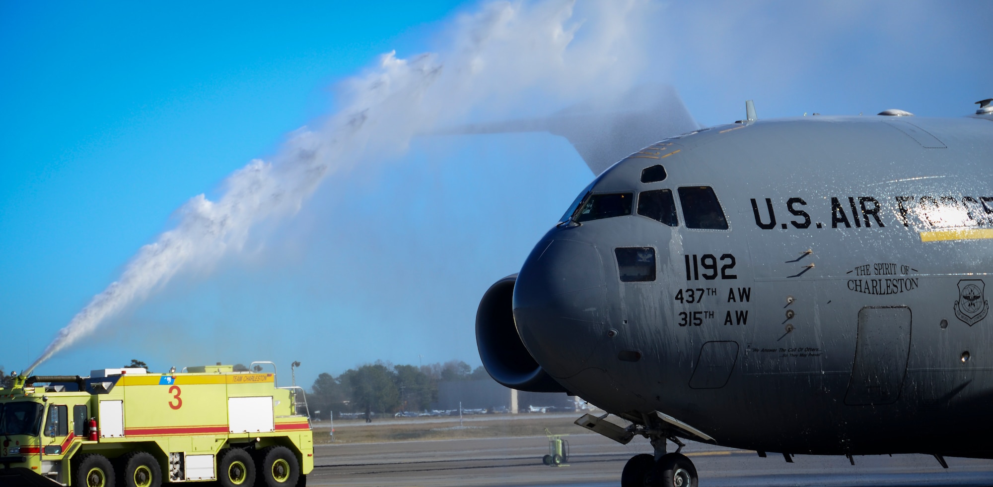 C-17 Globemaster III, Aircraft 9192, is doused with water by fire trucks during a ceremony December 18, 2013 at Joint Base Charleston – Air Base, S.C. The aircraft, nicknamed the “Spirit of Charleston” was the first C-17 in the U.S. Air Force’s inventory and has flown missions throughout the world for more than two decades. Those missions have totaled more than 20,000 flight hours. (U.S. Air Force photo/Staff Sgt. Anthony Hyatt)