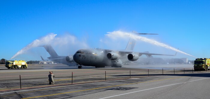 C-17 Globemaster III, Aircraft 9192, is doused with water by fire trucks during a ceremony December 18, 2013 at Joint Base Charleston – Air Base, S.C. The aircraft, nicknamed the “Spirit of Charleston” was the first C-17 in the U.S. Air Force’s inventory and has flown missions throughout the world for more than two decades. Those missions have totaled more than 20,000 flight hours. (U.S. Air Force photo/Staff Sgt. Anthony Hyatt)