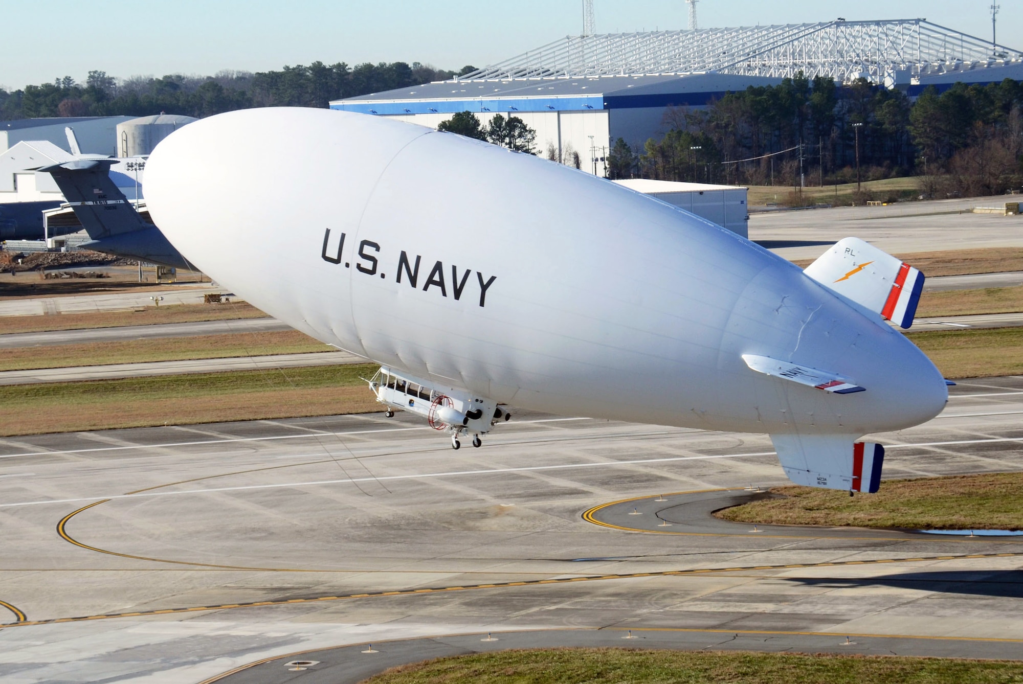 The United States Navy manned airship, MZ-3A lifts off the runway at Dobbins Air Reserve Base, Ga. Dec. 17. The Navy’s only airship based at Patuxent River, Md., stopped at Dobbins on its way to a winter location in central Florida, so that scientists from Georgia Institute of Technology Research facility could take measurements for systems integration work Dec. 14-16. (U.S. Air Force photo/Don Peek)
