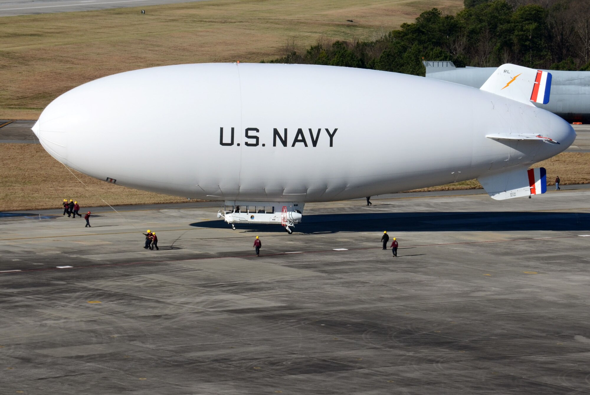 Ground crews maneuver the United States Navy manned airship, MZ-3A into takeoff position as it prepares to depart Dobbins Air Reserve Base, Ga. Dec. 17. The Navy’s only airship based at Patuxent River, Md., stopped at Dobbins on its way to a winter location in central Florida, so that scientists from Georgia Institute of Technology Research facility could take measurements for systems integration work Dec. 14-16. (U.S. Air Force photo/Don Peek)