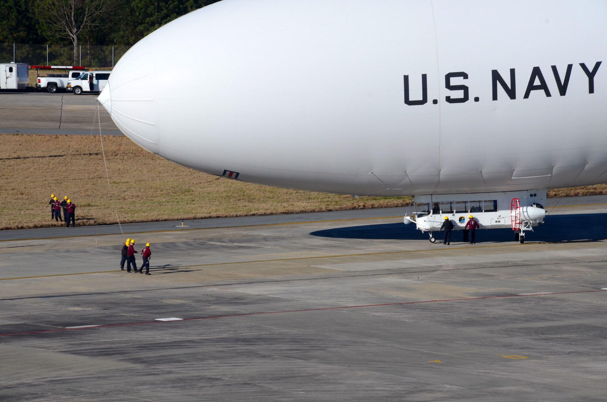 Ground crews maneuver the United States Navy manned airship, MZ-3A into takeoff position as it prepares to depart Dobbins Air Reserve Base, Ga. Dec. 17. The Navy’s only airship based at Patuxent River, Md., stopped at Dobbins on its way to a winter location in central Florida, so that scientists from Georgia Institute of Technology Research facility could take measurements for systems integration work Dec. 14-16. (U.S. Air Force photo/Don Peek)