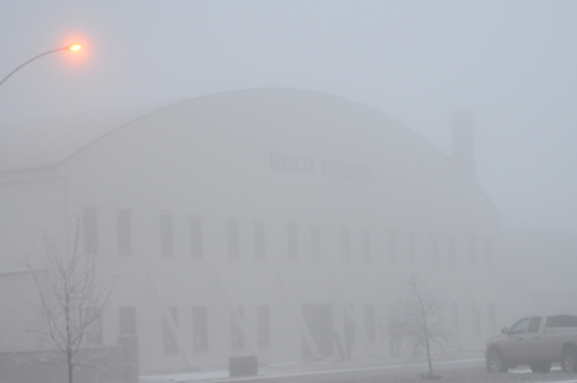 The 391st Aircraft Maintenance Squadron hangar is barely visable through the fog Dec. 18, 2013, at Mountain Home Air Force Base, Idaho. Airmen have worked in extremely foggy conditions every morning this week in order to get the aircraft flying. (U.S. Air Force photo by Senior Airman Benjamin Sutton/Released)