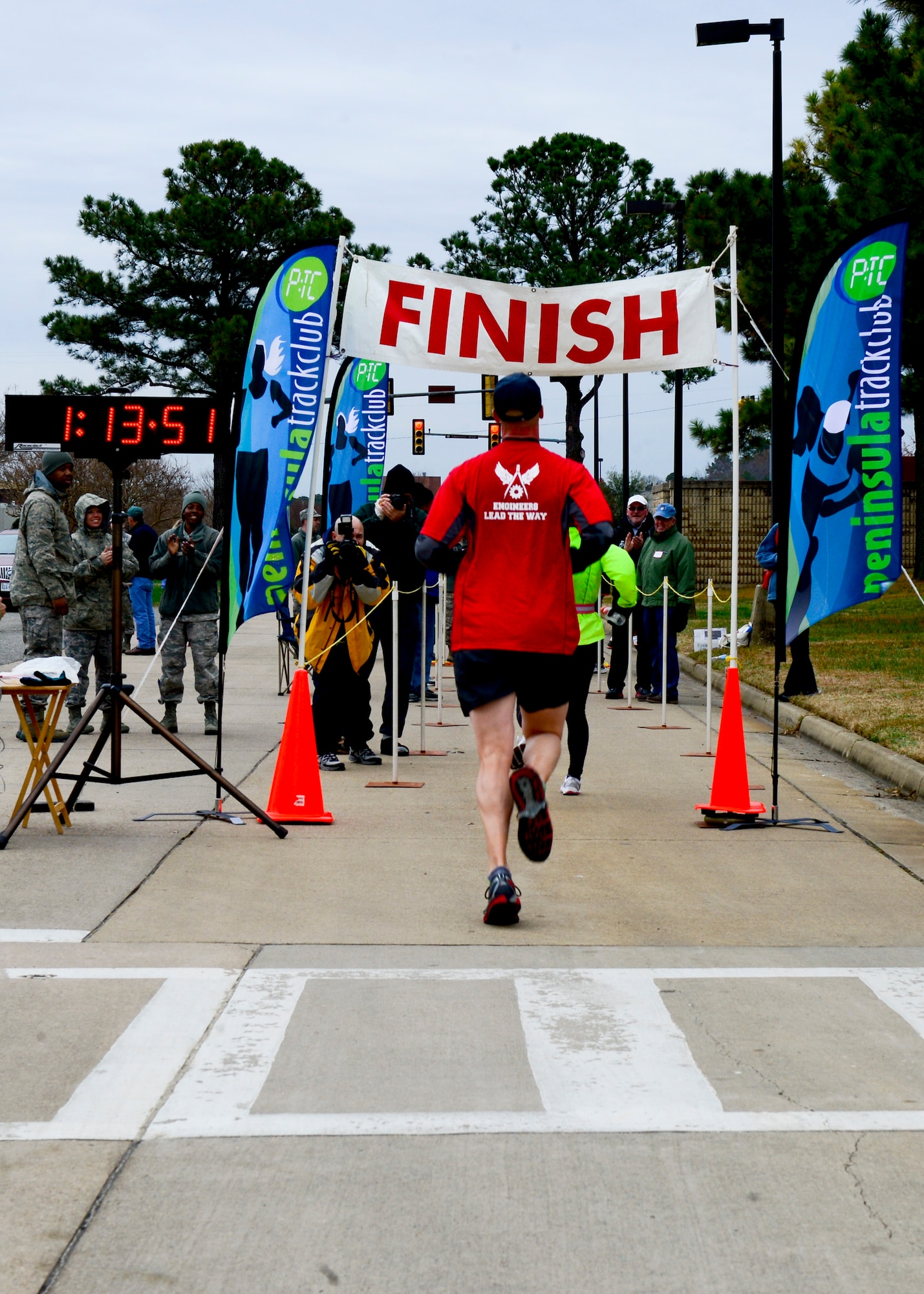 U.S. Air Force Lt. Col. Dee Katzer, 633rd Civil Engineer Squadron commander, finishes the 4th annual “Race 'Round the Base” at Langley Air Force Base, Va., Dec. 14, 2013. Upon completion, all runners received a medal. (U.S. Air Force photo by Staff Sgt. John D. Strong II / Released)