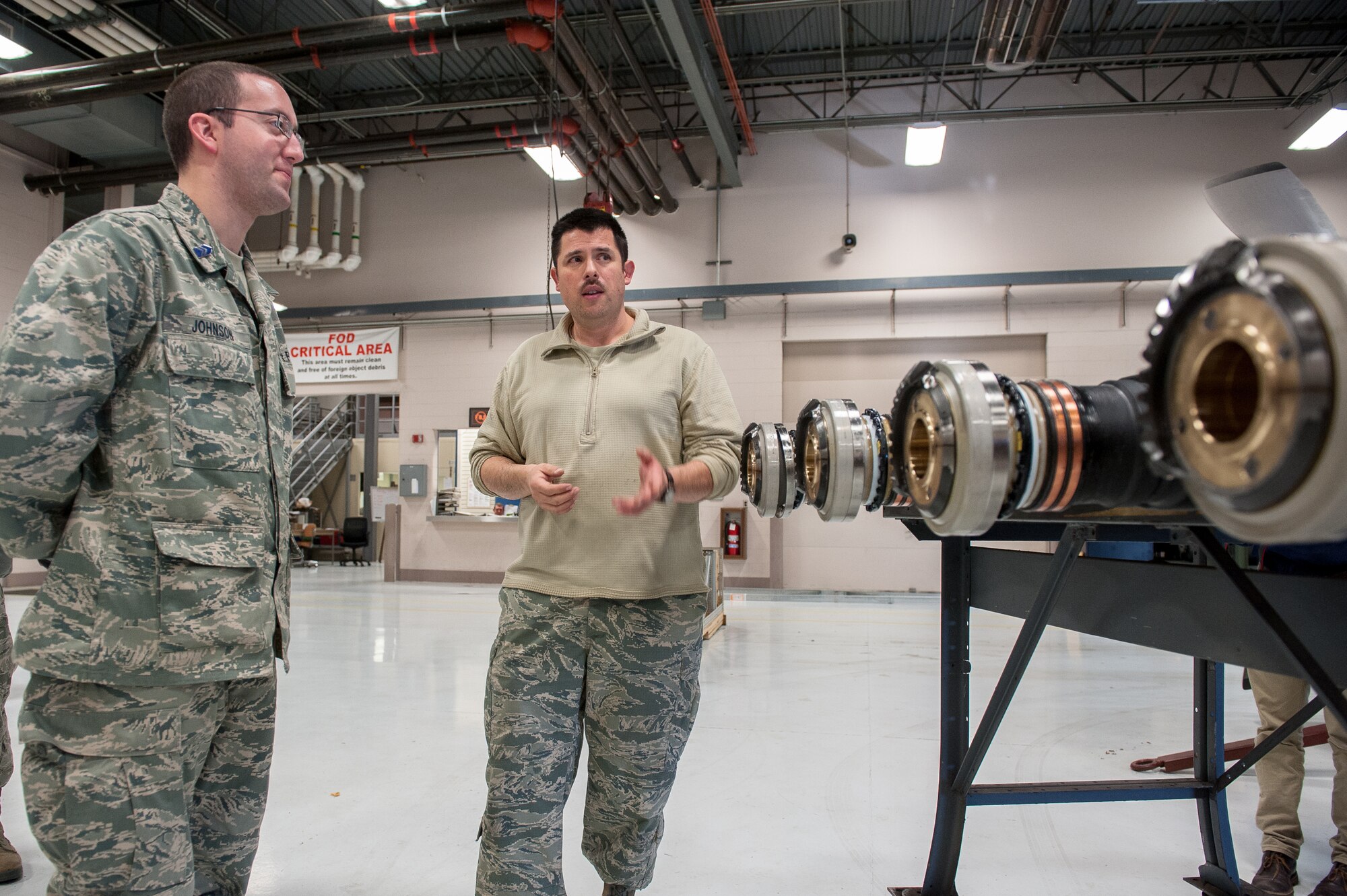 Tech. Sgt. Chuck Rodgers, an engine mechanic from the 123rd Maintenance Squadron, discusses C-130 propulsion systems with U.S. Air Force Reserve Officer Training Corps Cadet 3rd Class Trevor Johnson during a tour of the Kentucky Air National Guard Base in Louisville, Ky., Nov. 19, 2013. Johnson is assigned to Detachment 295, which is based at the University of Louisville. (U.S. Air National Guard photo by Maj. Dale Greer)