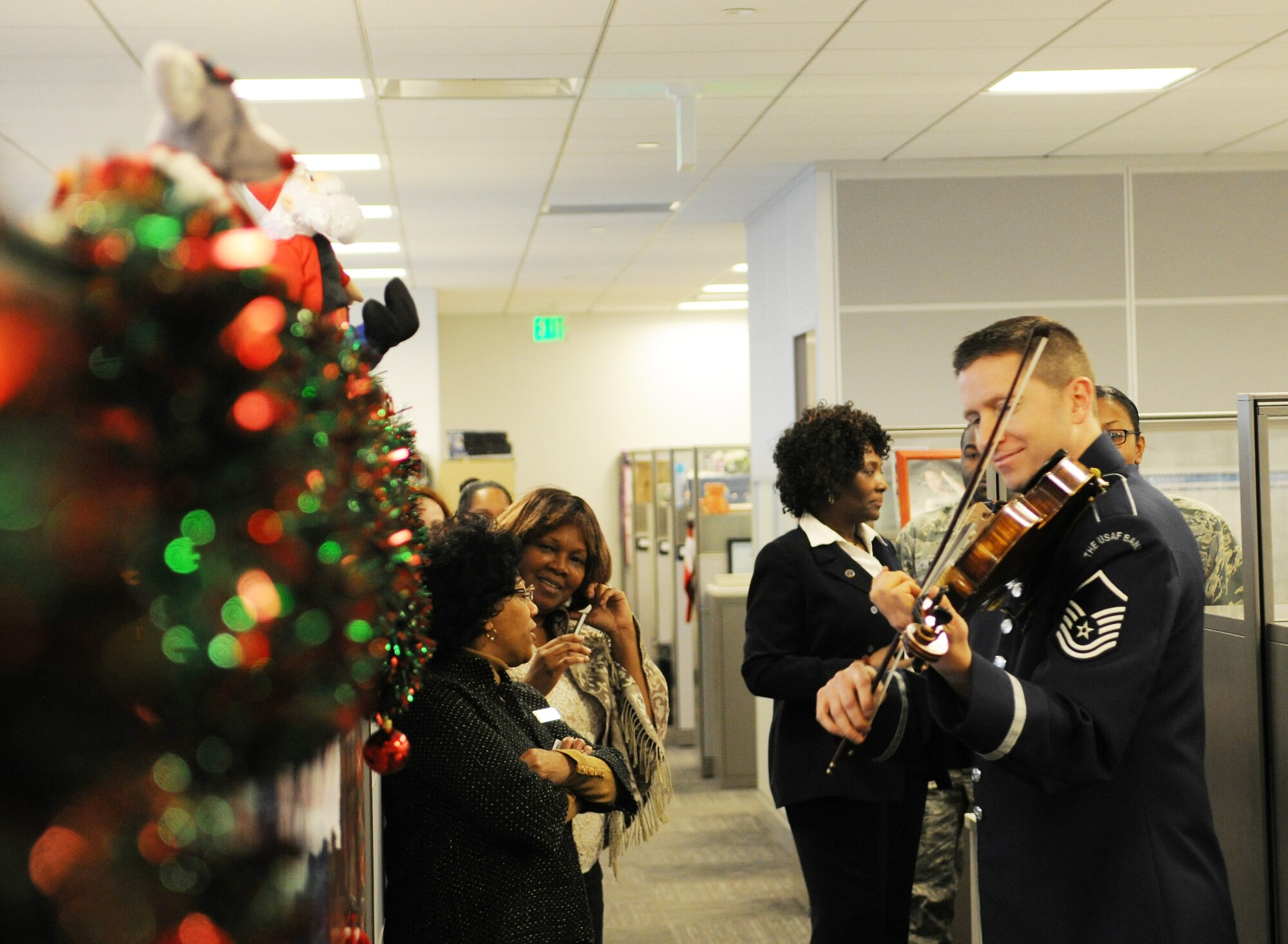 Master Sgt. Bryce Bunner, violist with The U.S. Air Force Band’s Strolling Strings, and other band members play holiday music for the offices around the Jones Building, Joint Base Andrews, Md., Dec. 17. Bunner is also the assistant Non-commissioned officer in charge of the Strolling Strings and began his Air Force career in 1999.(U.S. Air Force photo/Airman 1st Class Ryan J. Sonnier)