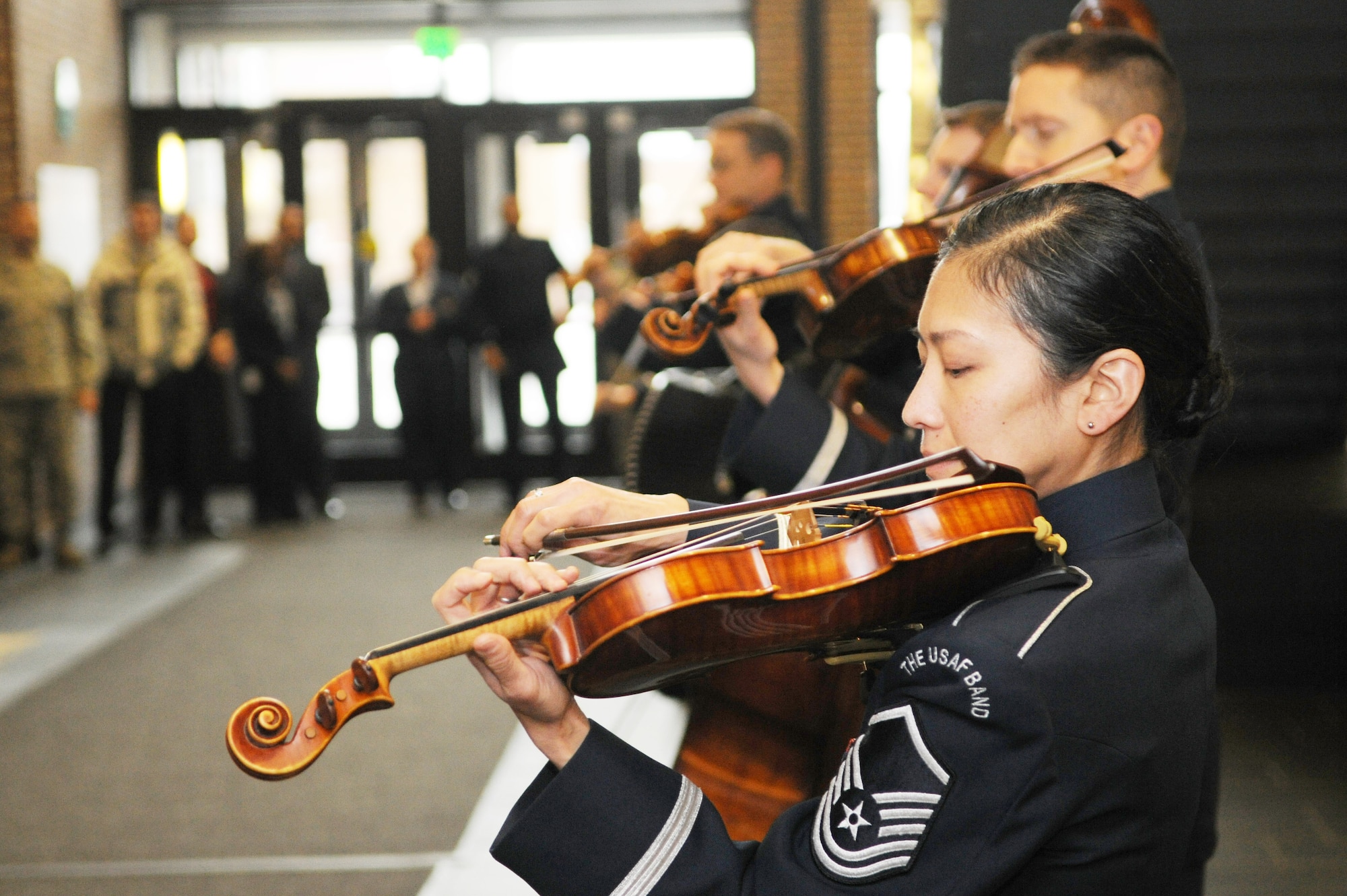 Master Sgt. Mari Uehara Washington, violinist with The U.S. Air Force Band’s Strolling Strings, and other band members perform for a crowd at the William A. Jones III Building, Joint Base Andrews, Md., Dec. 17. Washington is also the Strolling Strings’ concertmaster and has been with the Air Force since 1999.(U.S. Air Force photo/Airman 1st Class Ryan J. Sonnier)