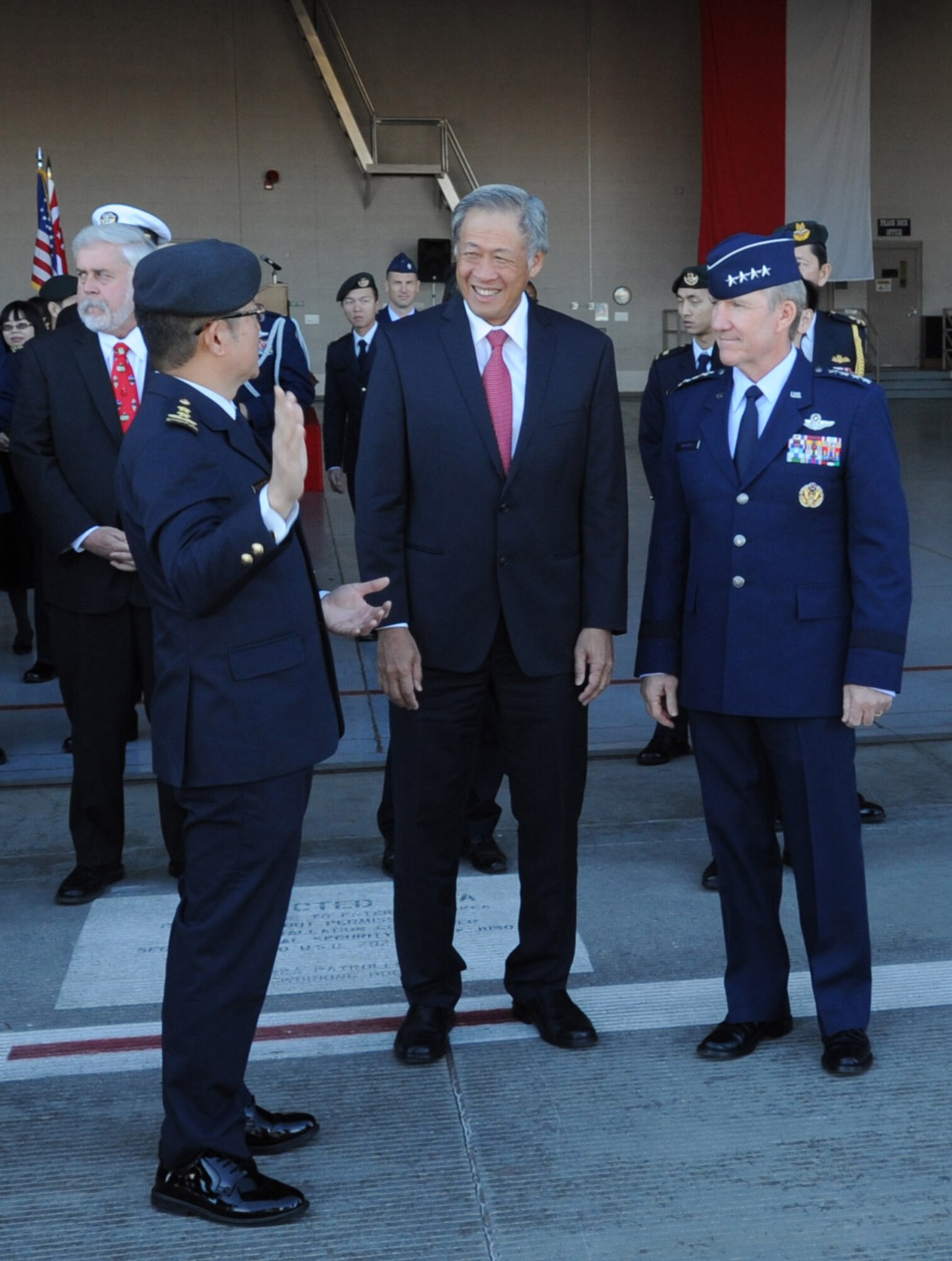 Maj. Gen. Hoo Cher Mou, Republic of Singapore chief of air force; Dr. Ng Eng Hen, Republic of Singapore minister of defense; and Gen. Hawk Carlisle, Pacific Air Forces commander, share a casual moment during the Peace Carvin II Parade Dec. 11at Luke Air Force Base, Ariz. The event marks 20 years of partnership between the Republic of Singapore Air Force and the U.S. Air Force. (U.S. Air Force photo by Staff Sgt. Luther Mitchell Jr.)
