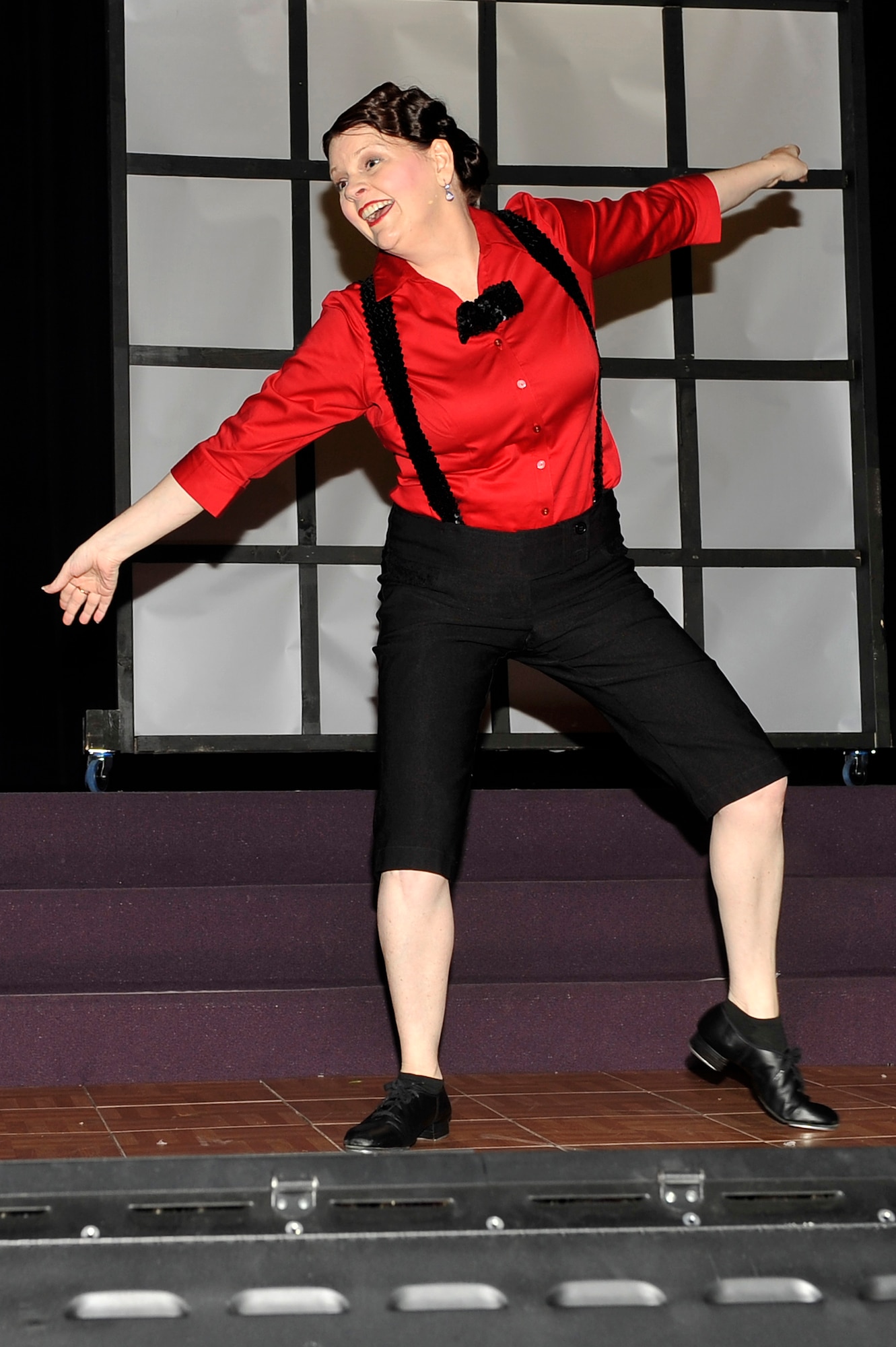 Kim White performs a tap dancing routine during a Christmas musical at Faith Family Church Dec. 6, 2013 Shiloh, Ill. White experienced a perforated colon in 2009, and performed for the first time in about five years. White is the wife of Col. Timothy White who is assigned to Air Mobility Command. (U.S. Air Force photo/Airman 1st Class Jaeda Waffer)