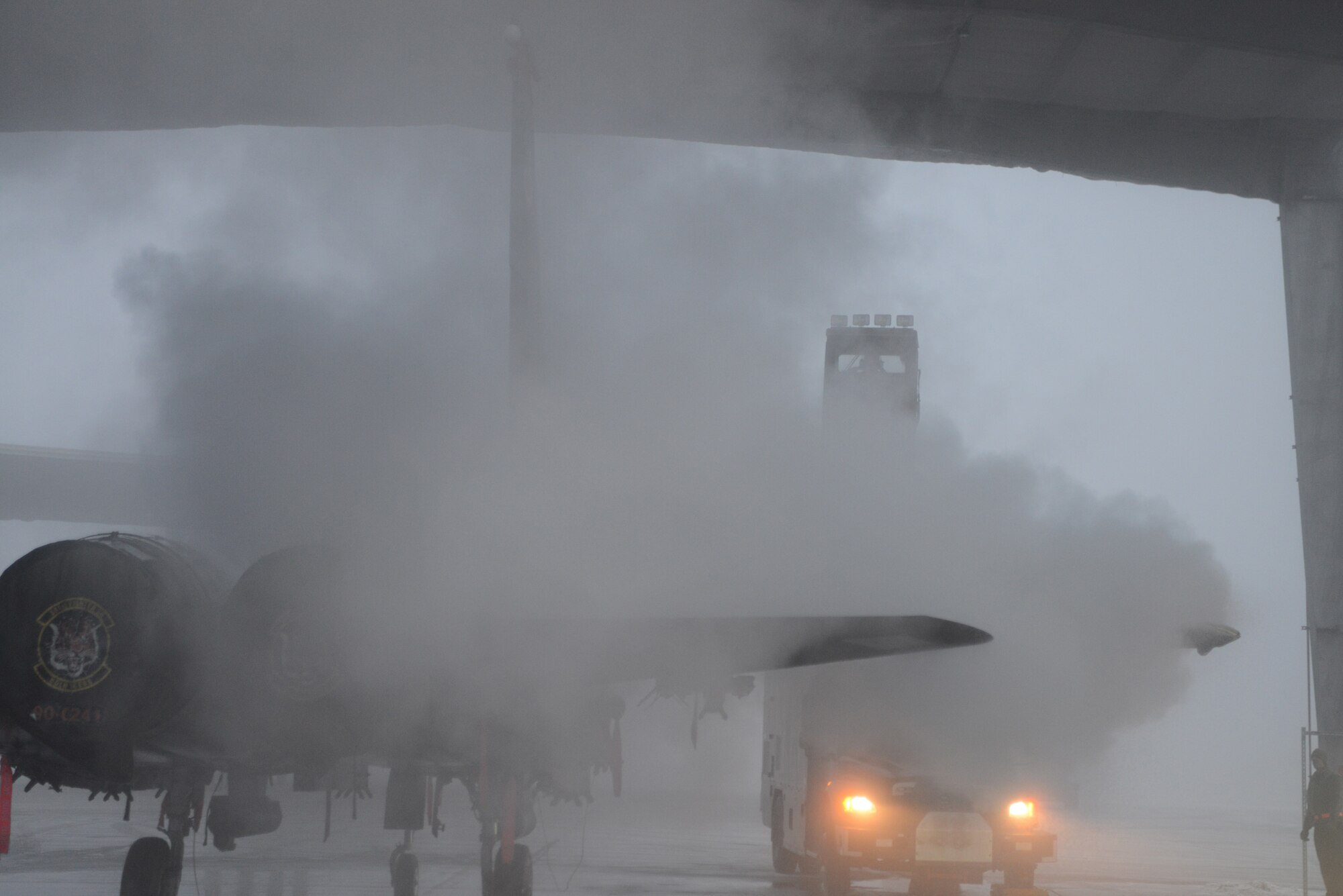 Airmen from the 366th Aircraft Maintenance Squadron de-ice an F-15E Strike Eagle Dec. 18, 2013, at Mountain Home Air Force Base, Idaho. In order for the aircraft to safely fly, all ice must be removed from key areas on the jets. (U.S. Air Force photo by Senior Airman Benjamin Sutton/Released)