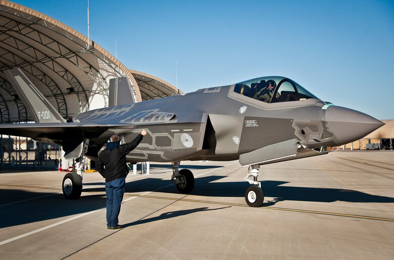 Maj. Laurens Vijge, a Royal Netherlands Air Force pilot, salutes his Lockheed Martin crew chief as he taxis out for the first flight in the F-35A Lightning II.  Vijge became the first RNLAF pilot to fly the joint strike fighter and the flight marks the first sortie for the RNLAF here.  (U.S. Air Force photo/Samuel King Jr.)