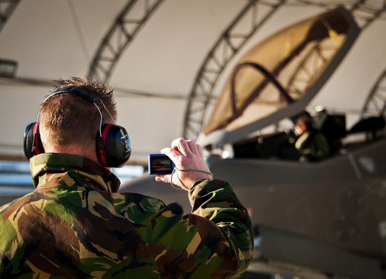 Sgt. 1st Class Terry Van Rooij, a maintainer with the Royal Netherlands Air Force, takes a picture of the Dutch F-35A Lightning II prior to its first flight Dec. 18 at Eglin Air Force Base, Fla.  Maj. Laurens Vijge became the first RNLAF pilot to fly the joint strike fighter and the flight marks the first sortie for the RNLAF here.  (U.S. Air Force photo/Samuel King Jr.)