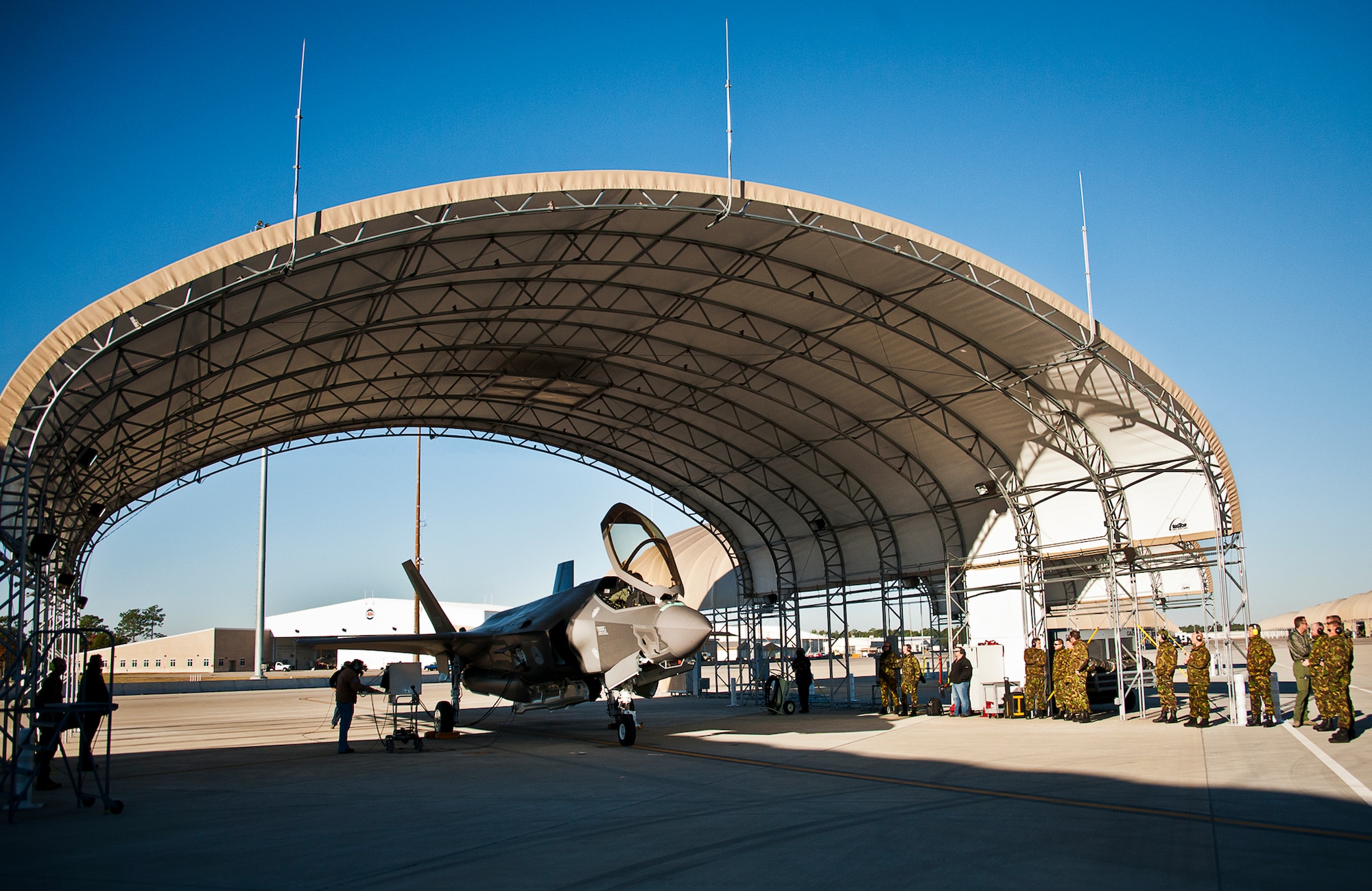Members of the Royal Netherlands Air Force watch as their F-35A Lightning II prepares to taxi out for its first flight Dec. 18 at Eglin Air Force Base, Fla.  Maj. Laurens Vijge became the first RNLAF pilot to fly the joint strike fighter and the flight marks the first sortie for the RNLAF here.  (U.S. Air Force photo/Samuel King Jr.)