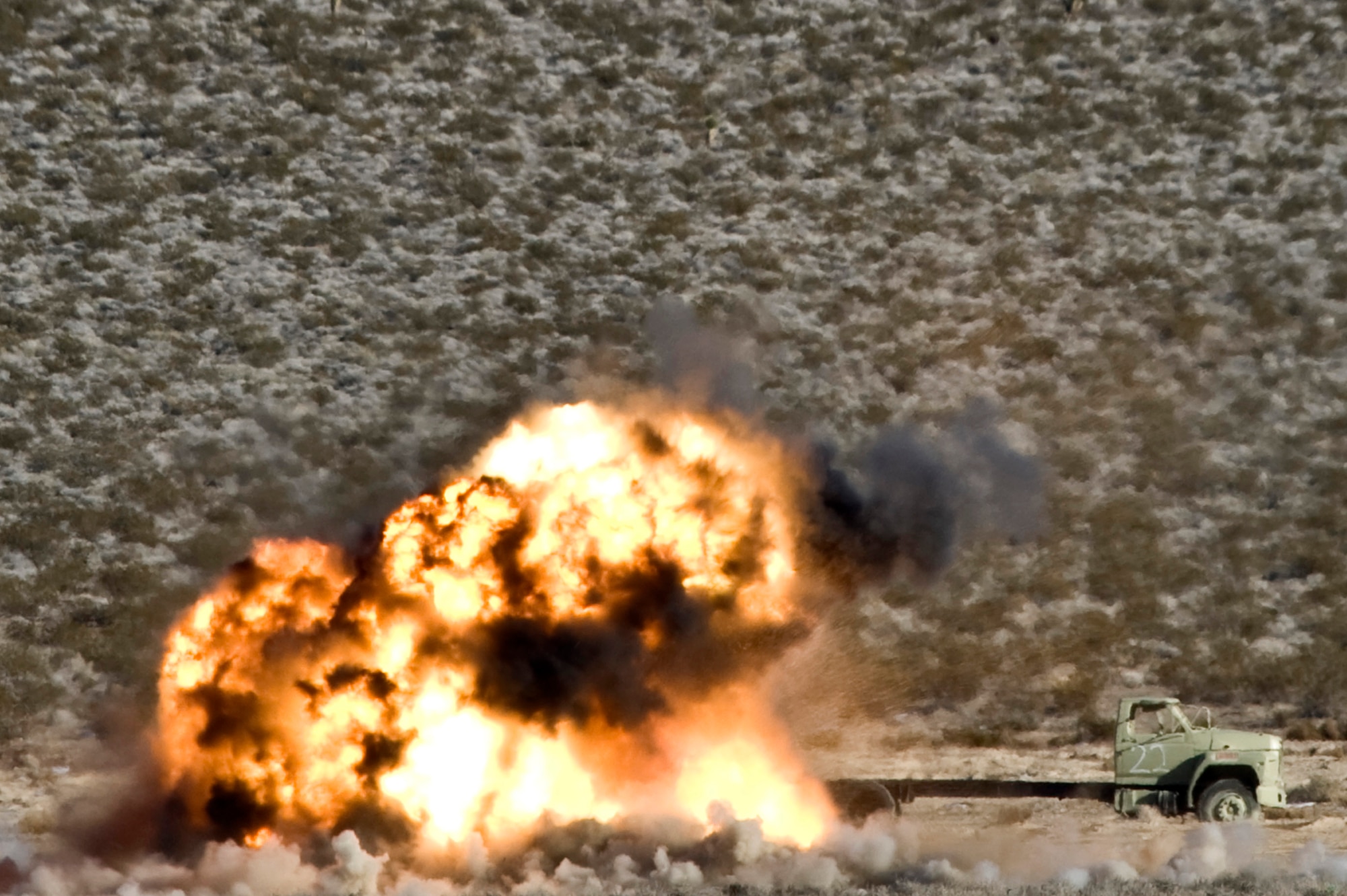 An AGM-114 Hellfire air-to-surface missile explodes on a target during a Handheld Laser Marker Tactics Development and Evaluation project Dec. 12, 2013, at the Nevada Test and Training Range, Nev. The LA-10u/PEQ handheld laser marker sends out a pulse repetition frequency code which is synchronized with the munition and guides it to an intended target. (U.S. Air Force photo by Senior Airman Matthew Lancaster)