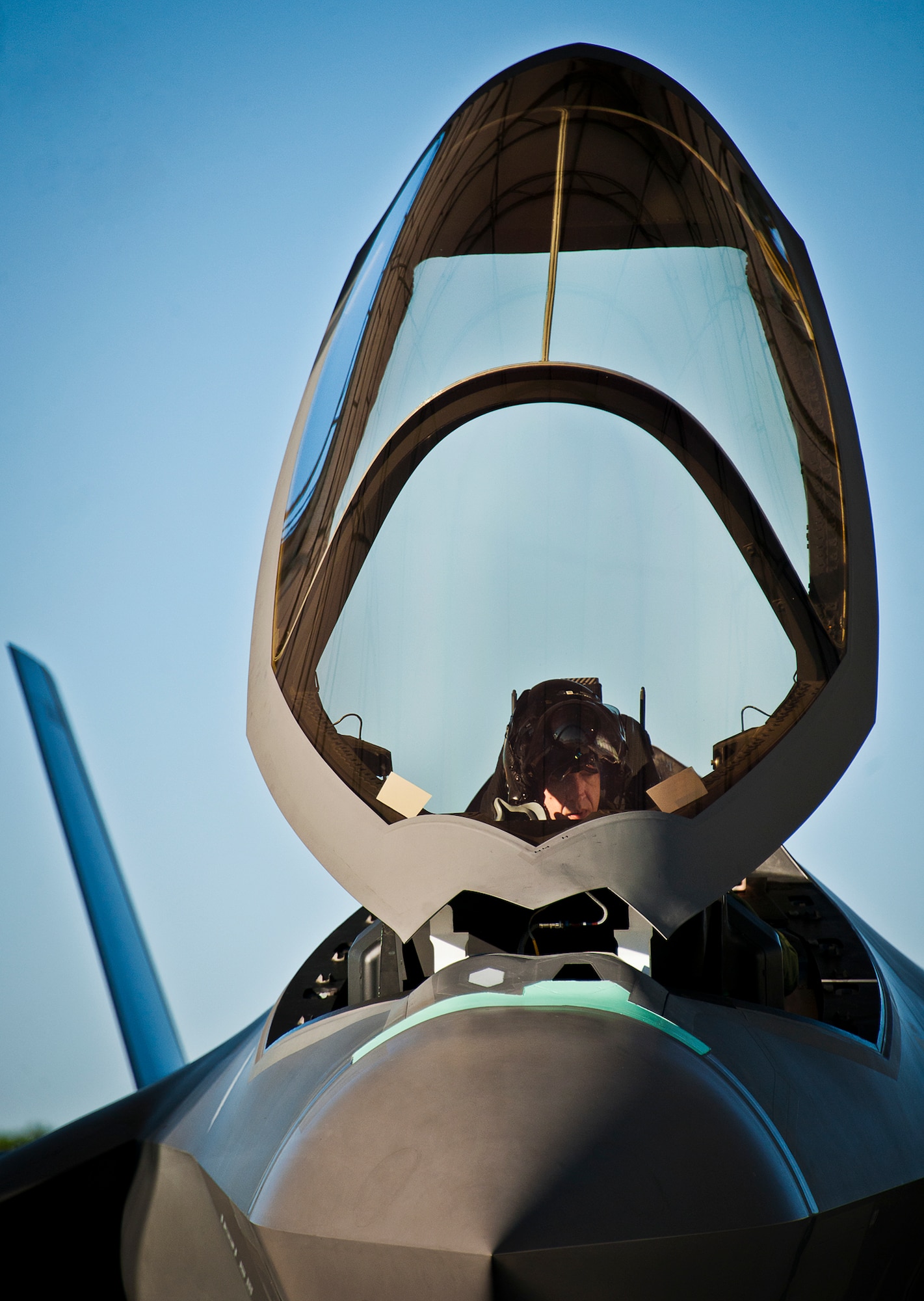 Maj. Laurens Vijge, a Royal Netherlands Air Force pilot, makes adjustments while in the seat of an F-35A Lightning II prior to his first flight in the aircraft Dec. 18 at Eglin Air Force Base, Fla.  Vijge became the first RNLAF pilot to fly the joint strike fighter and the flight marks the first sortie for the RNLAF here.  (U.S. Air Force photo/Samuel King Jr.)
