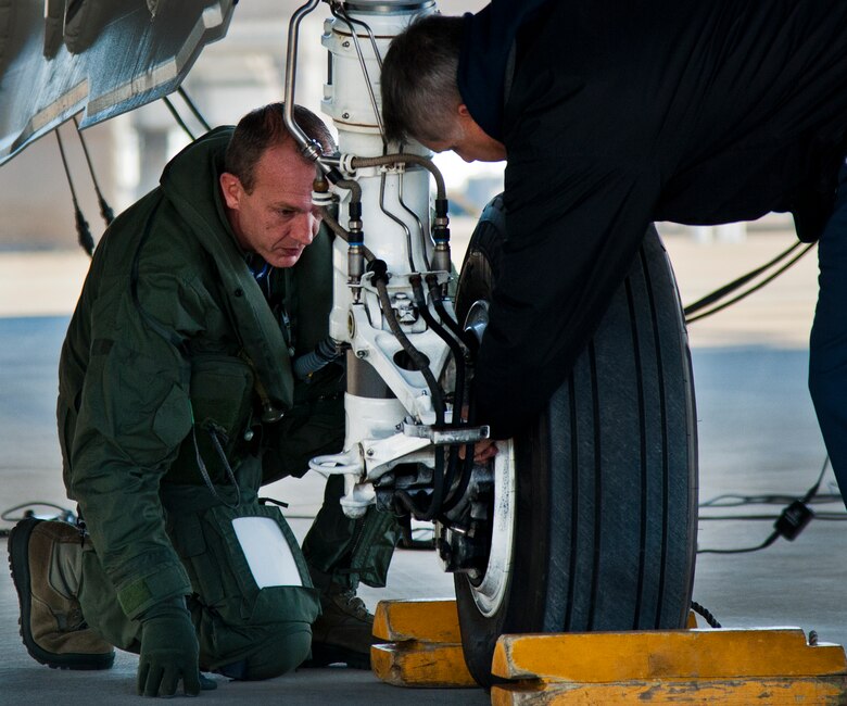 Maj. Laurens Vijge, Royal Netherlands Air Force pilot, examines the wheel of an F-35A Lightning II with a Lockheed Martin maintainer during a preflight check Dec. 18 at Eglin Air Force Base, Fla.  Vijge became the first RNLAF pilot to fly the joint strike fighter and the flight marks the first sortie for the RNLAF here.  (U.S. Air Force photo/Samuel King Jr.)
