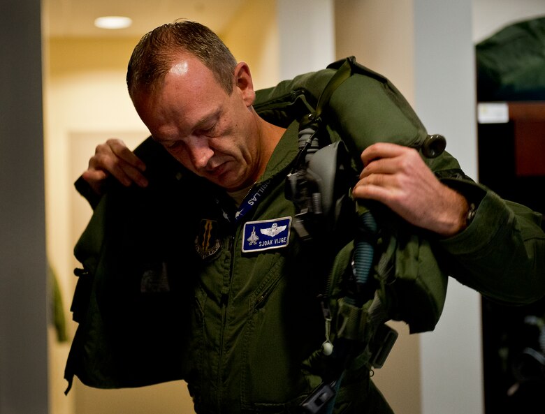Maj. Laurens Vijge, a Royal Netherlands Air Force pilot, dresses in his life support equipment prior to his first flight in the F-35A Lightning II Dec. 18 at Eglin Air Force Base, Fla.  Vijge became the first RNLAF pilot to fly the joint strike fighter and the flight marks the first sortie for the RNLAF here.  (U.S. Air Force photo/Samuel King Jr.)