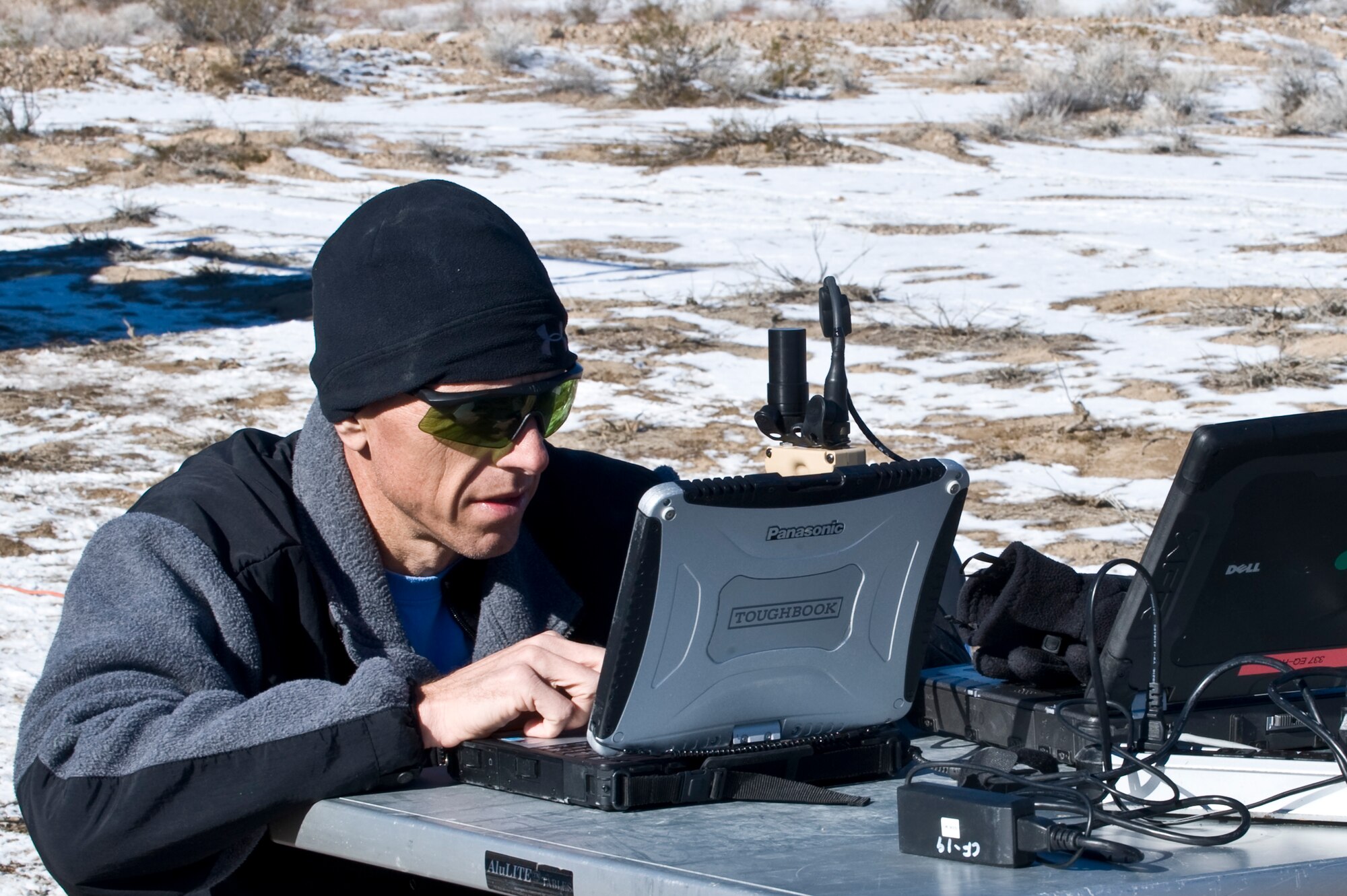 David Howard, 605th Test and Evaluation Squadron project manager, monitors video feed from the camera of an A-10 Thunderbolt II from Nellis Air Force Base, Nev., during a Handheld Laser Marker Tactics Development and Evaluation project Dec. 10, 2013 on the Nevada Test and Training Range, Nev. The evaluation was a week-long event to gather capability data on the LA-10u/PEQ handheld laser marker. (U.S. Air Force photo by Senior Airman Matthew Lancaster)