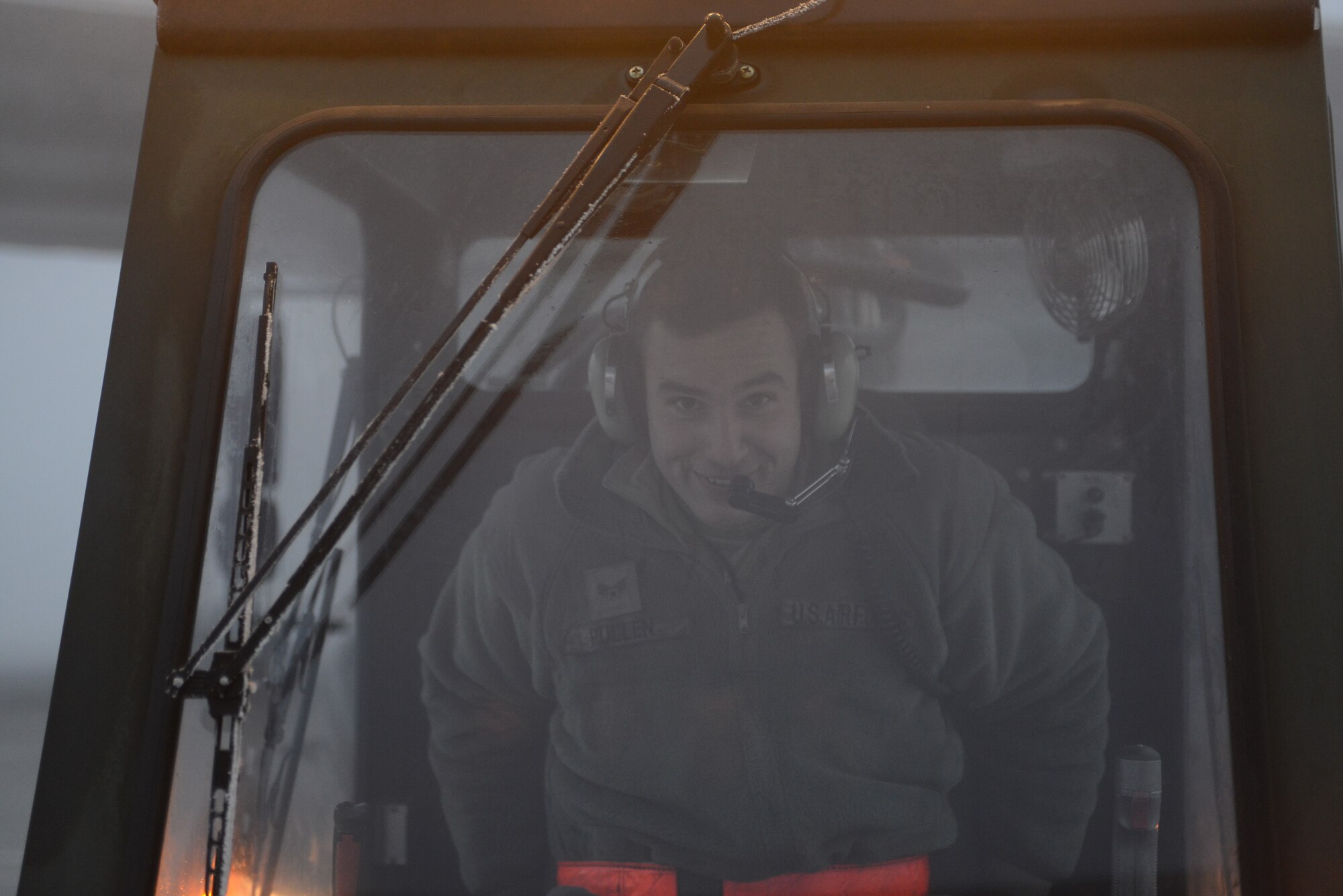 U.S. Air Force Senior Airmen Blake Pullen, 366th Aircraft Maintenance Squadron crew chief, smiles for a photo Dec. 18, 2013, at Mountain Home Air Force Base, Idaho. The foggy and cold conditions forced Airmen to de-ice aircraft on the flight line. (U.S. Air Force photo by Senior Airman Benjamin Sutton/Released)