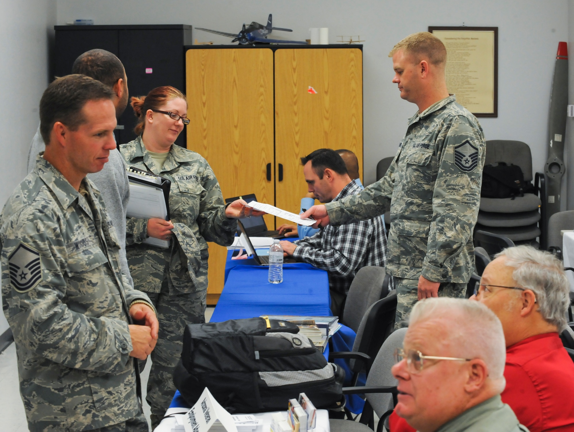 U.S. Air Force Airmen speak to different agency representatives about future plans during Capstone at the education center at Davis-Monthan Air Force Base, Ariz., Dec. 10, 2013. Capstone should be completed 90 days prior to separation/retirement, but exceptions will be made for short-notice administrative discharges or medical discharges. During this event, they will also have the chance to talk to veteran support agencies and employers to answer any remaining questions. (U.S. Air Force photo by Senior Airman Sivan Veazie/Released)