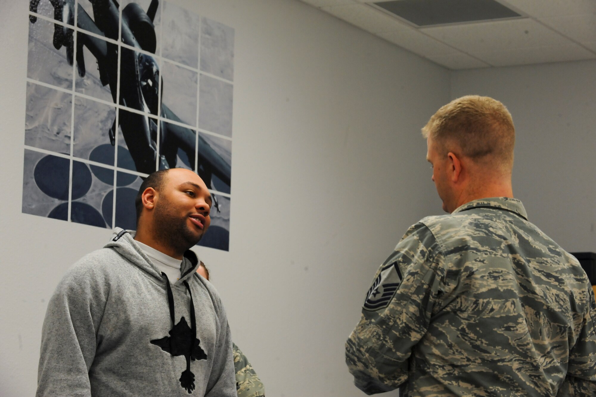 U.S. Air Force Senior Airman Brian Handley, 755th Aircraft Maintenance Squadron electronic warfare craftsman, speaks to Master Sgt. Adam Eldard, 355th Force Support Squadron in-service recruiter, during Capstone at Davis-Monthan Air Force Base, Ariz., Dec. 10, 2013. Capstone is the final piece of the transition assistance program.  After service members have completed their required and optional classes, they must attend the Capstone event to demonstrate they have met all career readiness standards. (U.S. Air Force photo by Senior Airman Sivan Veazie/Released)