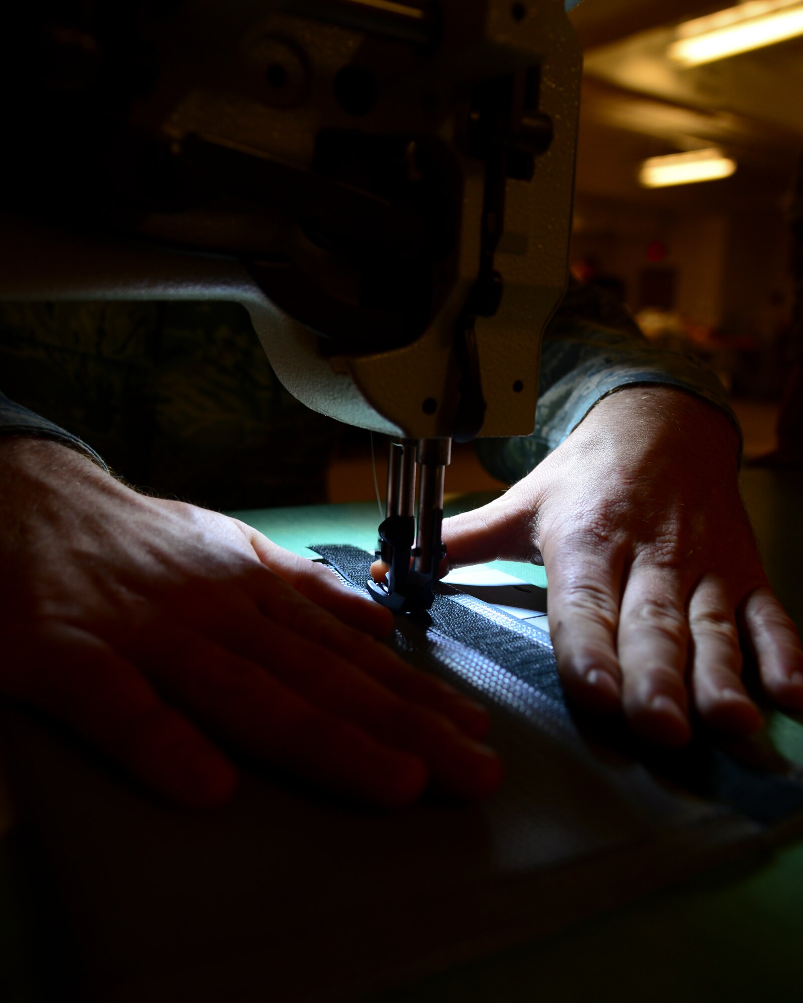 Senior Airman Taylor Clouse, 927th Air Refueling Wing aircrew flight equipment technician, practices sewing, Nov 20, 2013 at MacDill Air Force Base, Fla. AFE Airmen repair fabric and rubber components, including protective clothing, thermal radiation barriers, flotation equipment, and various parachutes. (U.S. Air Force photo by Senior Airman Melanie Bulow-Gonterman/Released)   