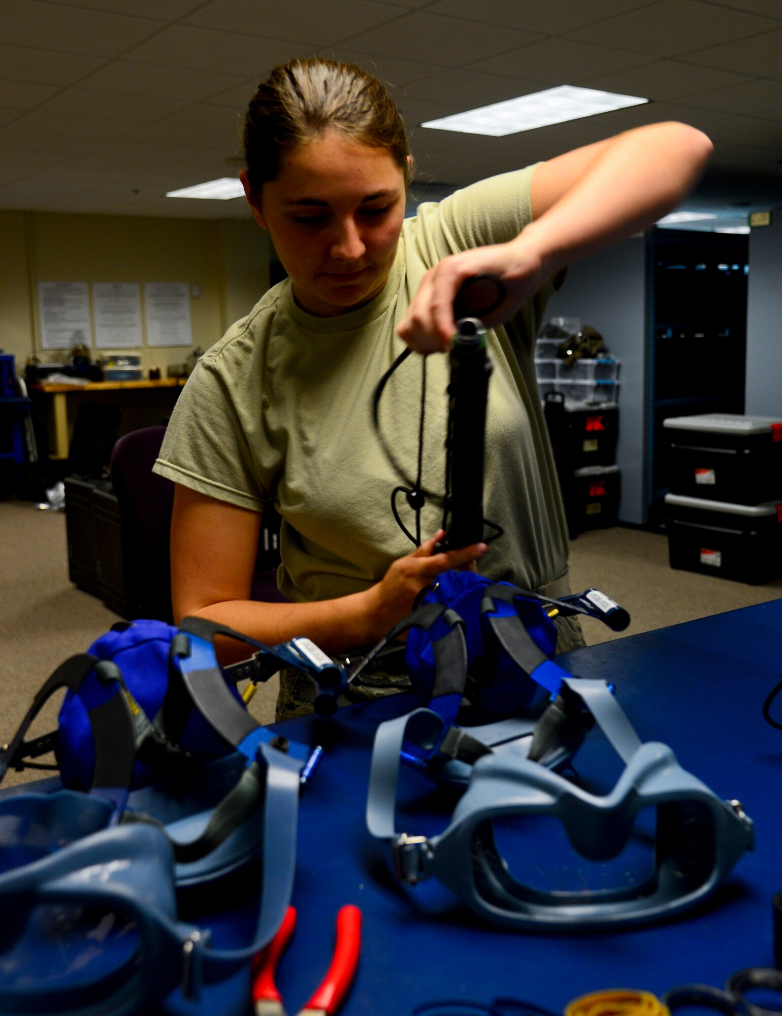 Senior Airman Amanda Kresky, 6th Operations Support Squadron aircrew flight equipment apprentice, inspects Scott 358 Quick Don masks, Nov 20, 2013 at MacDill Air Force Base, Fla. The masks are inspected every 30 days and broken down for cleaning every 90 days. (U.S. Air Force photo by Senior Airman Melanie Bulow-Gonterman/Released)   