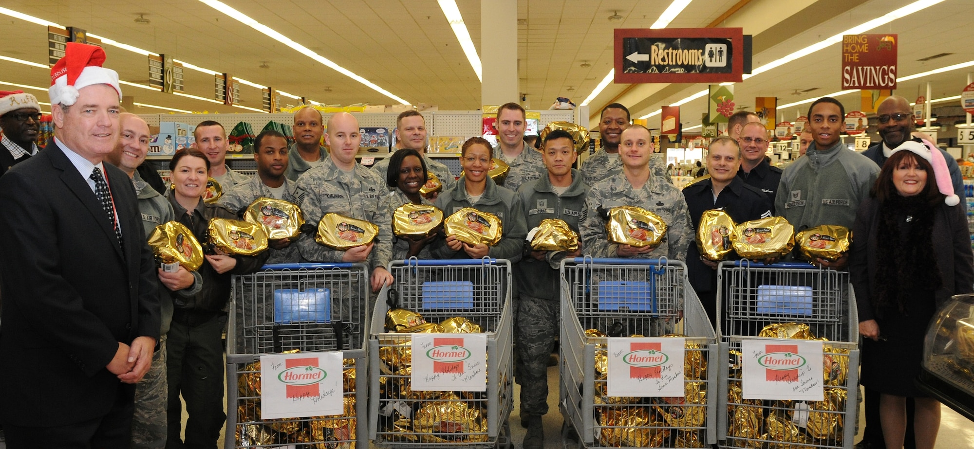 The Joint Base Andrews First Sergeant’s Council helps Airmen in need by giving out free hams at the Commissary Dec. 18, 2013. Hormel donated more than 100 hams as part of "Hams for Hunger" to give back to the community. The First Sergeant’s Council hosted the event to assist Airmen during the holidays. This is the first time the “Hams for Hunger” has come to JBA.(U.S. Air Force photo/Airman 1st Class Ryan J. Sonnier)