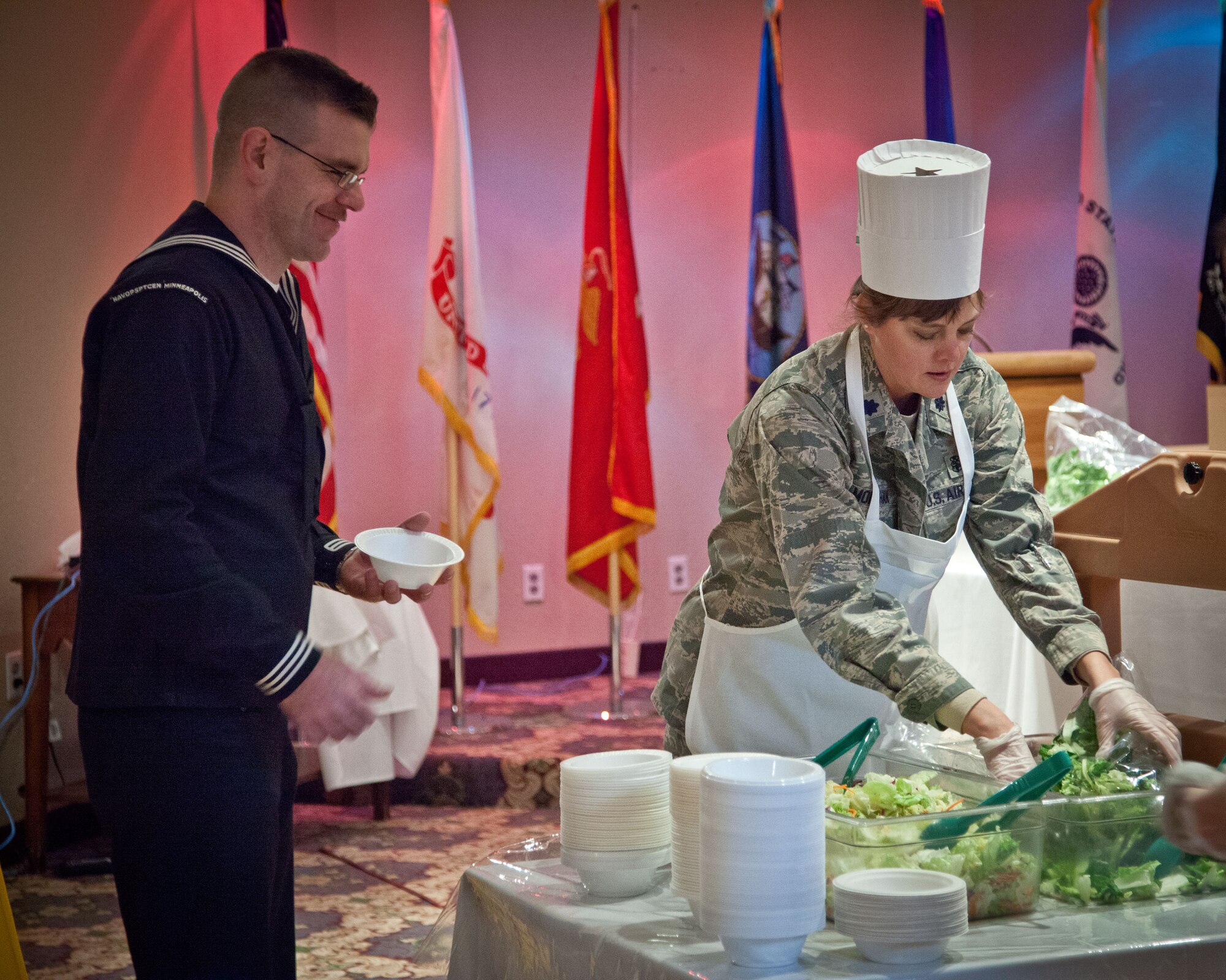 (Right) Lt. Col. Tracy Monahan, 934th Aeromedical Staging Squadron commander, and other 934th Airlift Wing leadership serve up the holiday meal for the troops at the Services Club during the December Unit Training Assembly weekend.  The Air Force, Navy, and Marine Corp Reserve units all held their monthly training this weekend at the Minneapolis-St. Paul Air Reserve Station, Minn.  (U.S. Air Force photo by Shannon McKay/Released)