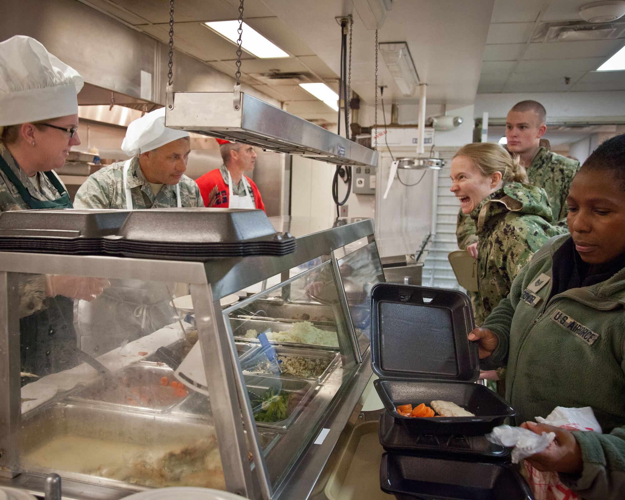 (From the left) Lt. Col. Bonnie Bosler, 934th Aeromedical Evacuation Squadron commander, Col. Todd McCubbin, 934th Airlift Wing commander, and Col. Keith Wesley, 934th Operations Group commander and other wing leadership serve up the holiday meal for the troops at the Services Club during the December Unit Training Assembly weekend.  The Air Force, Navy, and Marine Corp Reserve units all held their monthly training this weekend at the Minneapolis-St. Paul Air Reserve Station, Minn.  (U.S. Air Force photo by Shannon McKay/Released)