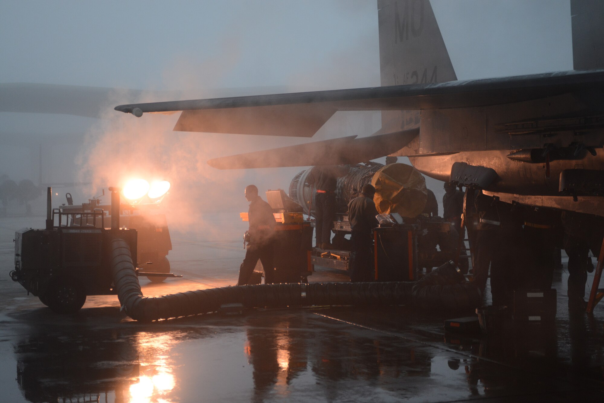 Airmen from the 366th Aircraft Maintenance Squadron replace an F-15E Strike Eagle engine Dec. 18, 2013, at Mountain Home Air Force Base, Idaho. The foggy conditions made work a bit more difficult on the flight line however, work went ahead as scheduled. (U.S. Air Force photo by Senior Airman Benjamin Sutton/Released)