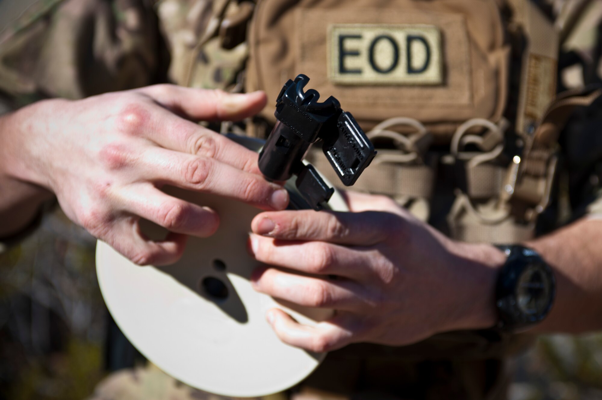 U.S. Air Force 1st Lt. Steve Bernero, 23rd Civil Engineering Squadron Explosive Ordnance Disposal Flight commander, Moody Air Force Base, Ga., prepares a modern demolitions initiator during an EOD counter-improvised explosive device training course Dec. 12, 2013, in Area 2 at Nellis AFB, Nev. Modern demolitions initiator is a suite of initiating components used to activate all standard military demolitions and explosives. (U.S. Air Force photo by Senior Airman Christopher Tam)
