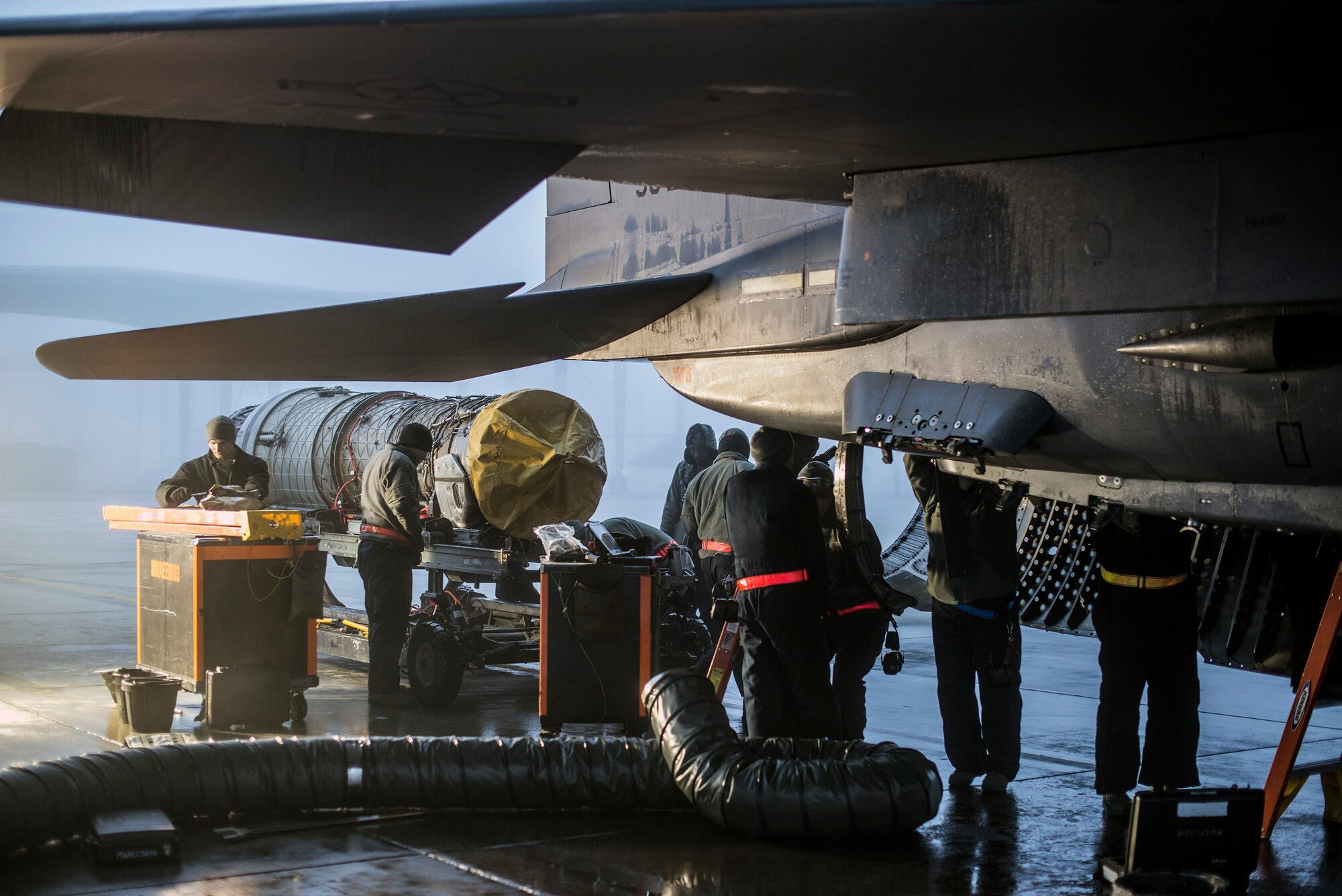 Air Force propulsion technicians inspect an F-15E Strike Eagle engine compartment, and service the engine at Mountain Home Air Force Base, Idaho, Dec. 18, 2013.  Proper and frequent maintenance is essential to sustaining aging Strike Eagle fleets, and 366th Maintenance Group Airmen work around the clock and in all elements to ensure Mountain Home’s warbirds are ready to fly at a moment’s notice. (U.S. Air Force photo by Master Sgt. Kevin Wallace/RELEASED)