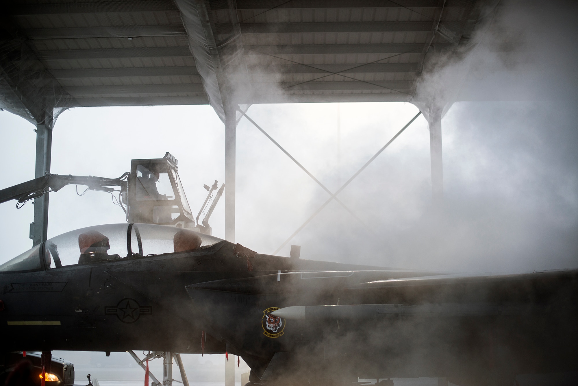 Air Force Senior Airman Blake Pullen, 366th Aircraft Maintenance Squadron crew chief, operates a ‘boom’ as he de-ices an F-15E Strike Eagle at Mountain Home Air Force Base, Idaho, Dec. 18, 2013. Preventing a build-up of snow and ice on the wings and tail is crucial for safe takeoff. (U.S. Air Force photo by Master Sgt. Kevin Wallace/RELEASED)