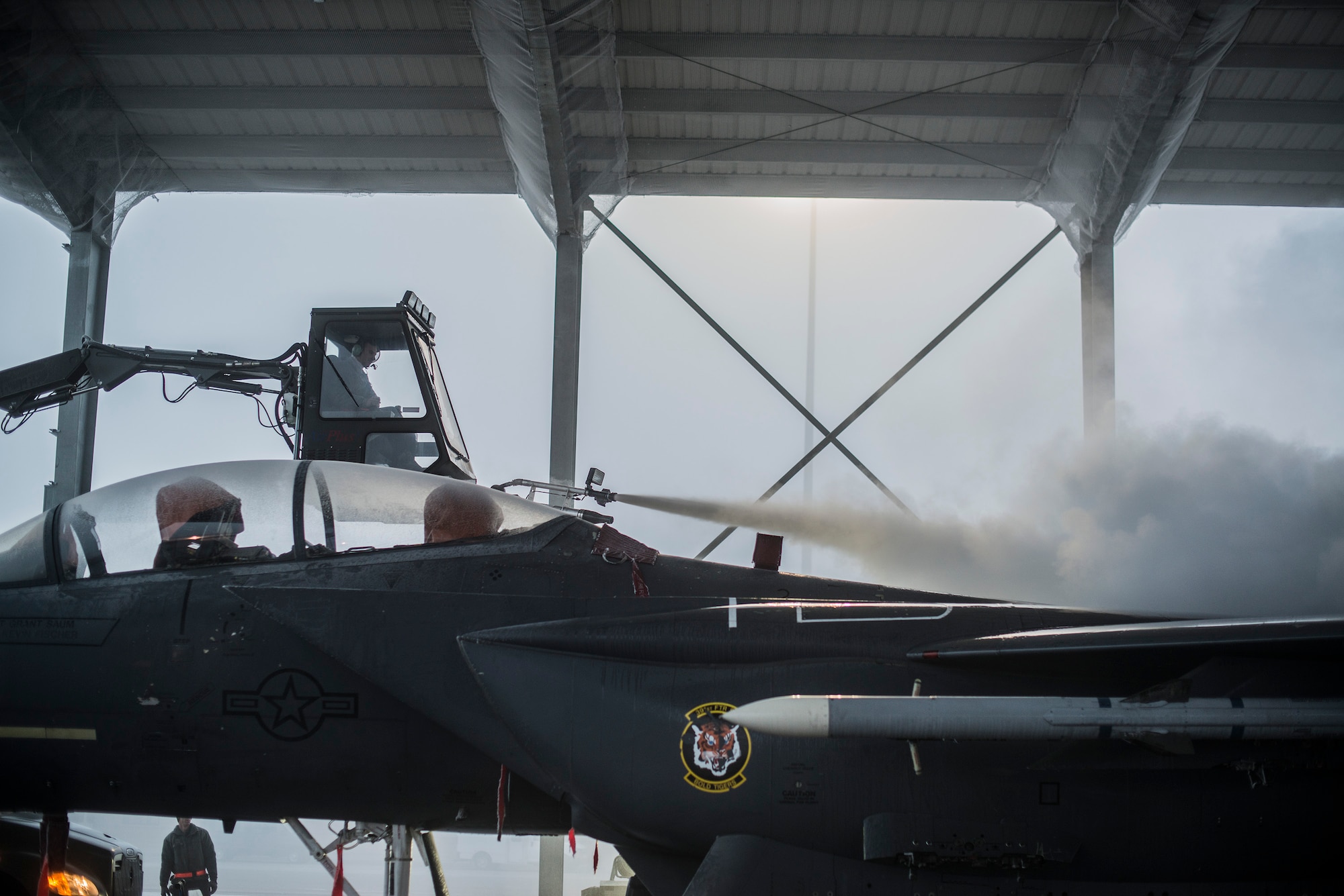 Air Force Senior Airman Blake Pullen, 366th Aircraft Maintenance Squadron crew chief, operates a ‘boom’ as he de-ices an F-15E Strike Eagle at Mountain Home Air Force Base, Idaho, Dec. 18, 2013. Like all aircraft, the Strike Eagle was designed with a very specific shape and size, to provide proper lift during flight, de-icing ensures safe and efficient flight operations. (U.S. Air Force photo by Master Sgt. Kevin Wallace/RELEASED)