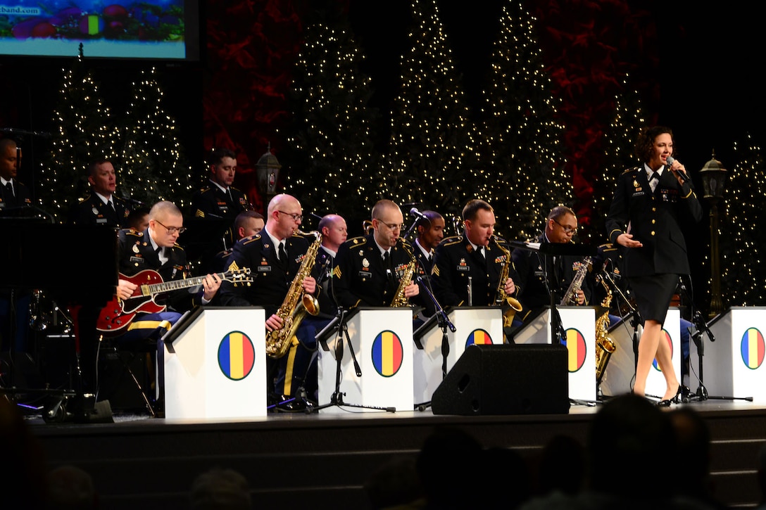 U.S. Army Spc. Anna Leverenz, Army Training and Doctrine Command Band musician, sings “Let it Snow” during the “Celebrate the Holidays” concert at Bethel Temple in Hampton, Va., Dec. 13, 2013. Leverenz sang two songs and performed two more as a French horn player during the free show. (U.S. Air Force photo by Staff Sgt. Ashley Hawkins/Released)