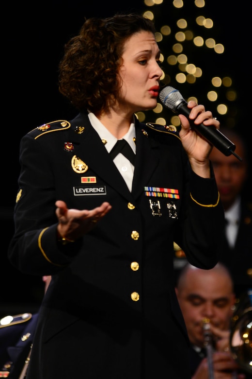 U.S. Army Spc. Anna Leverenz, Army Training and Doctrine Command Band musician, sings “Merry Christmas Darling” during the “Celebrate the Holidays” concert at Bethel Temple in Hampton, Va., Dec. 13, 2013. Leverenz, who is also a French horn player, was featured as the vocalist for the concert. (U.S. Air Force photo by Staff Sgt. Ashley Hawkins/Released)